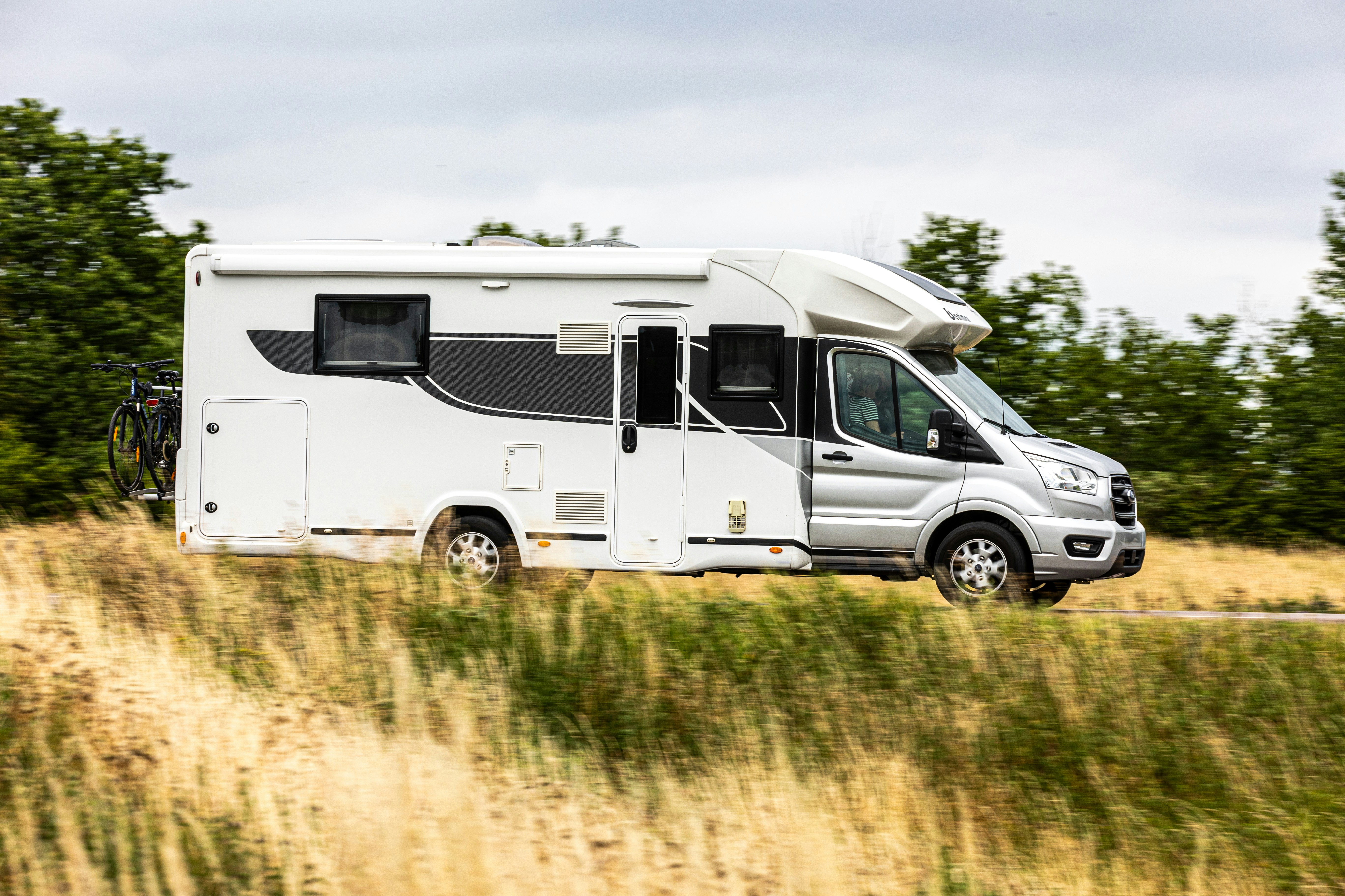A motorhome drives along a roadway.