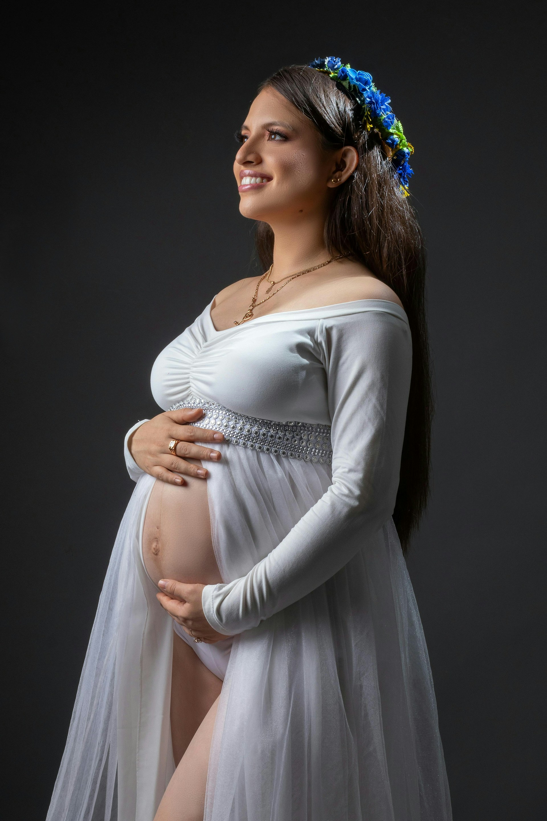 Pregnant woman smiles in her maternity shoot.