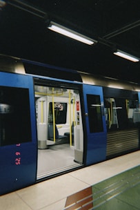 A subway train with open doors sits in a station.