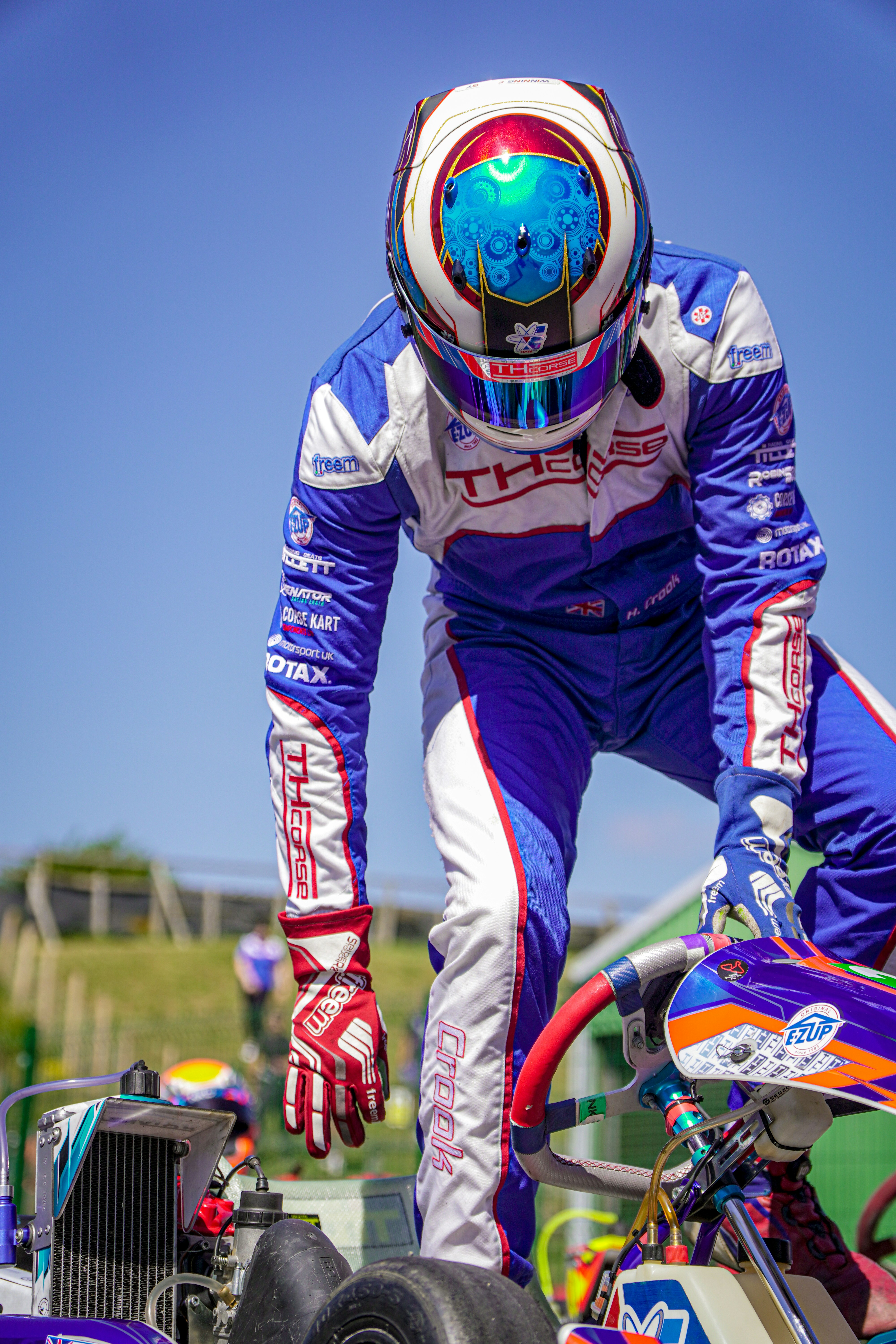 Go-kart racer in helmet prepares to start race