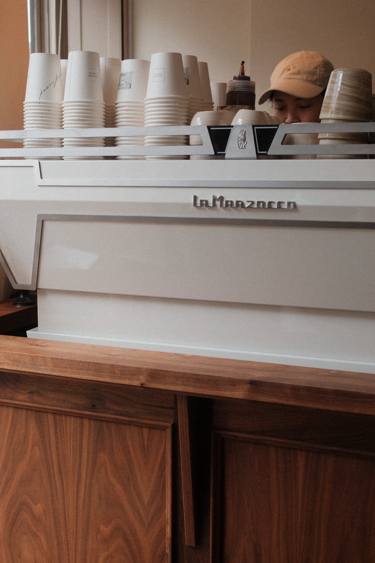 Barista preparing drinks behind an espresso machine