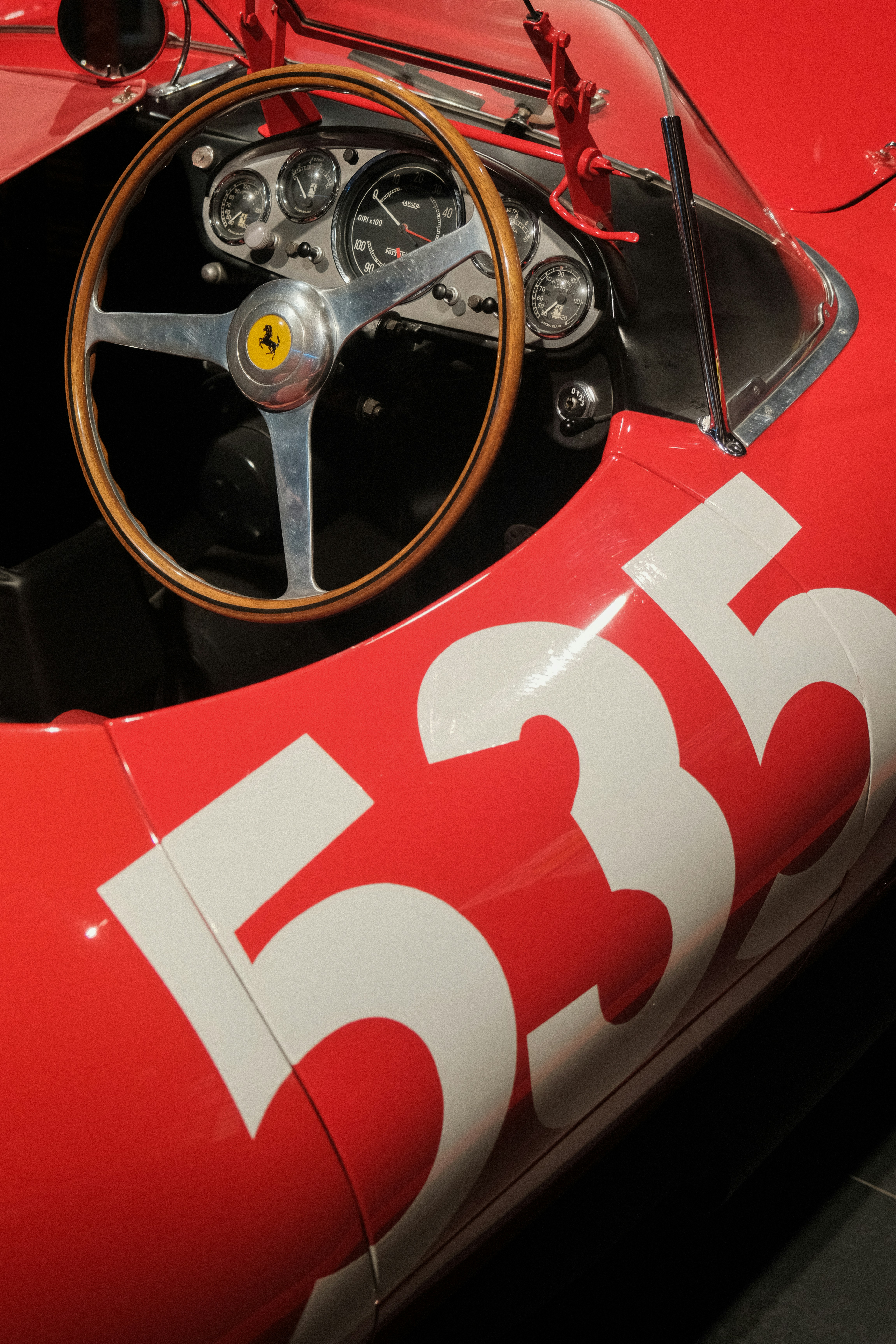 Interior view of a classic red ferrari race car.