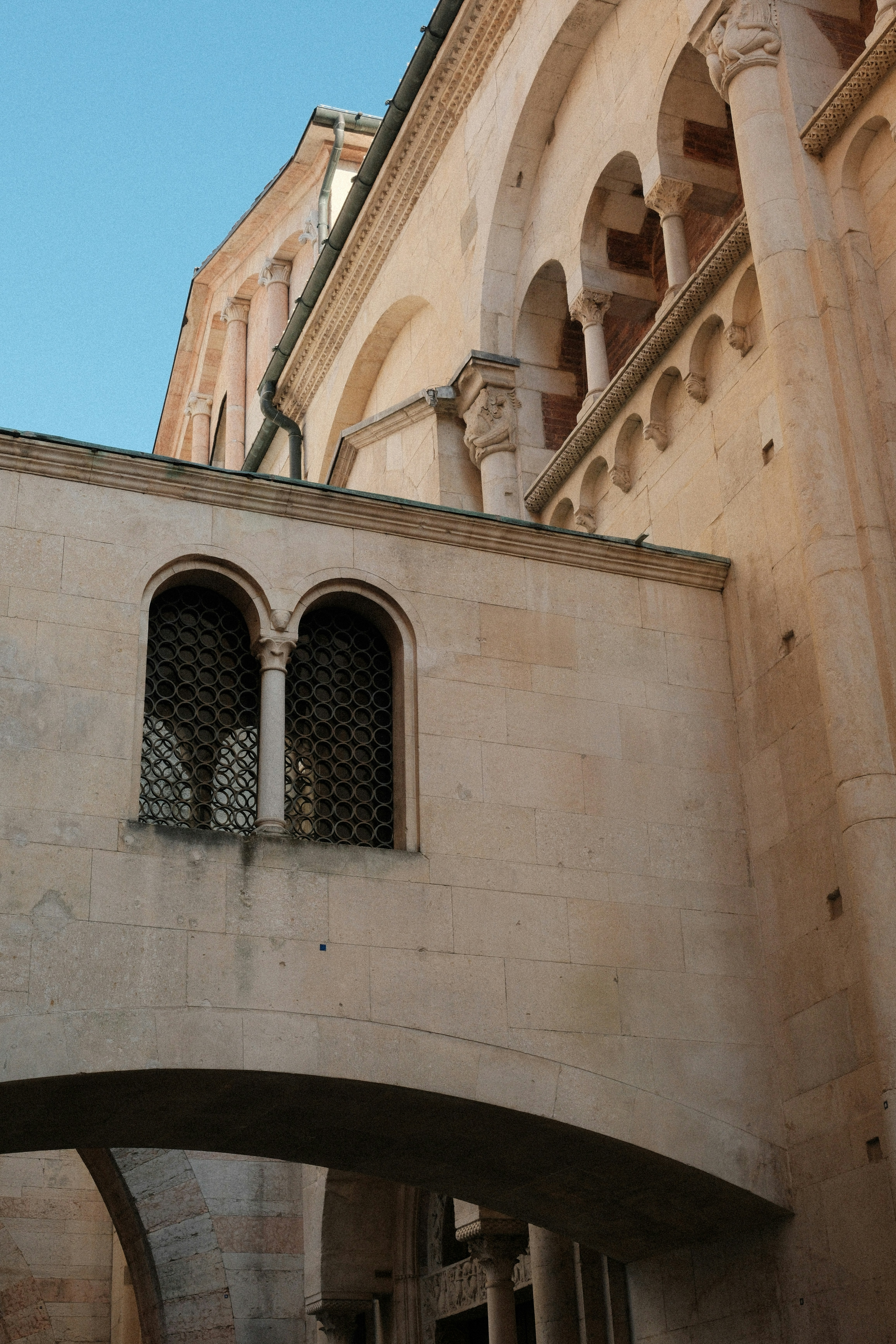 Medieval architecture with arched windows and bridges.