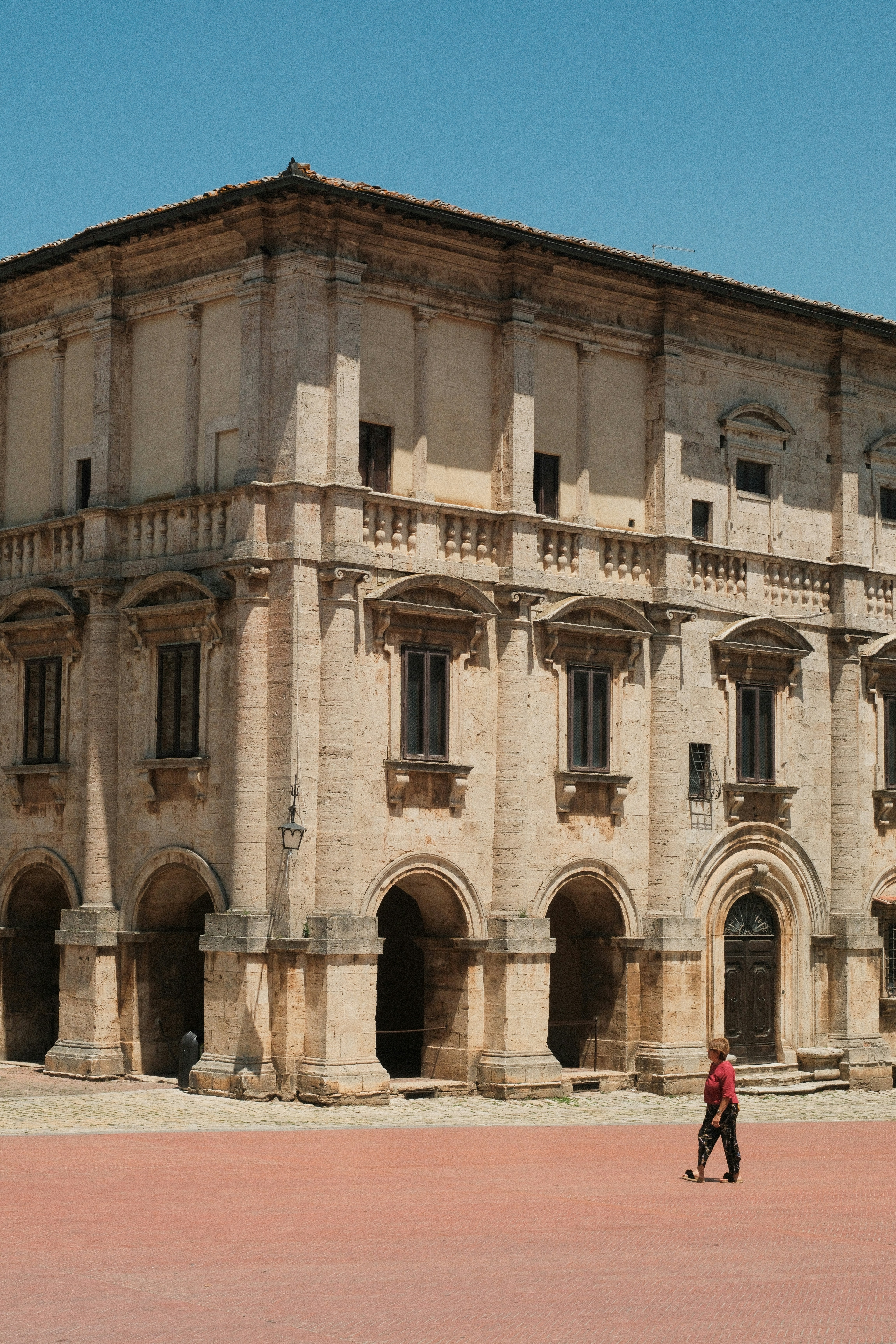 An old building stands in a sunny square.