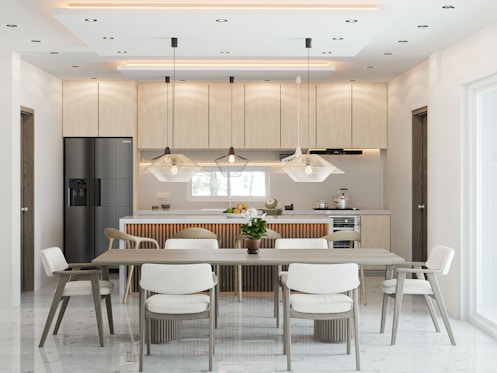 A modern kitchen and dining room with elegant furnishings.