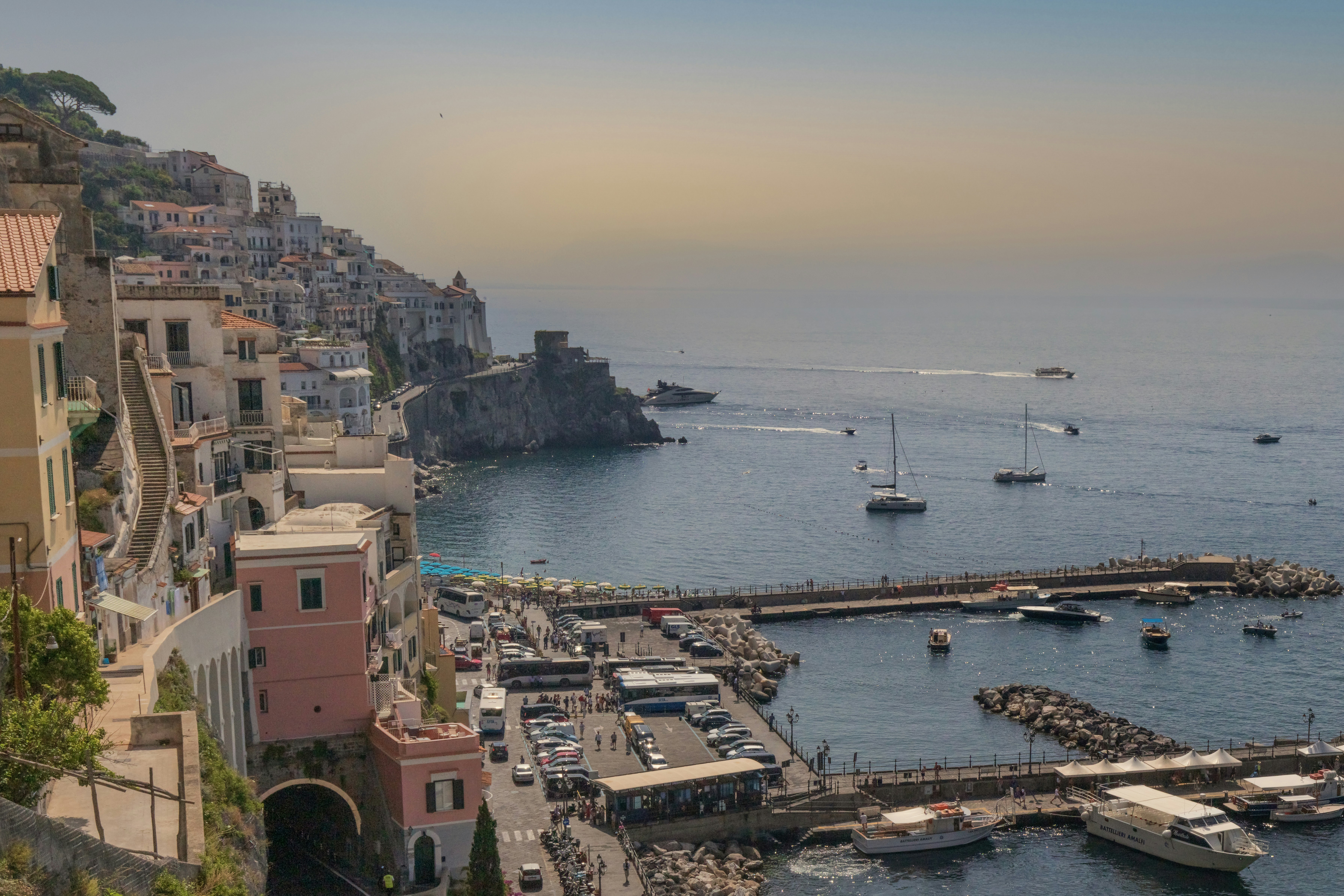 Coastal italian town with boats in the harbor.