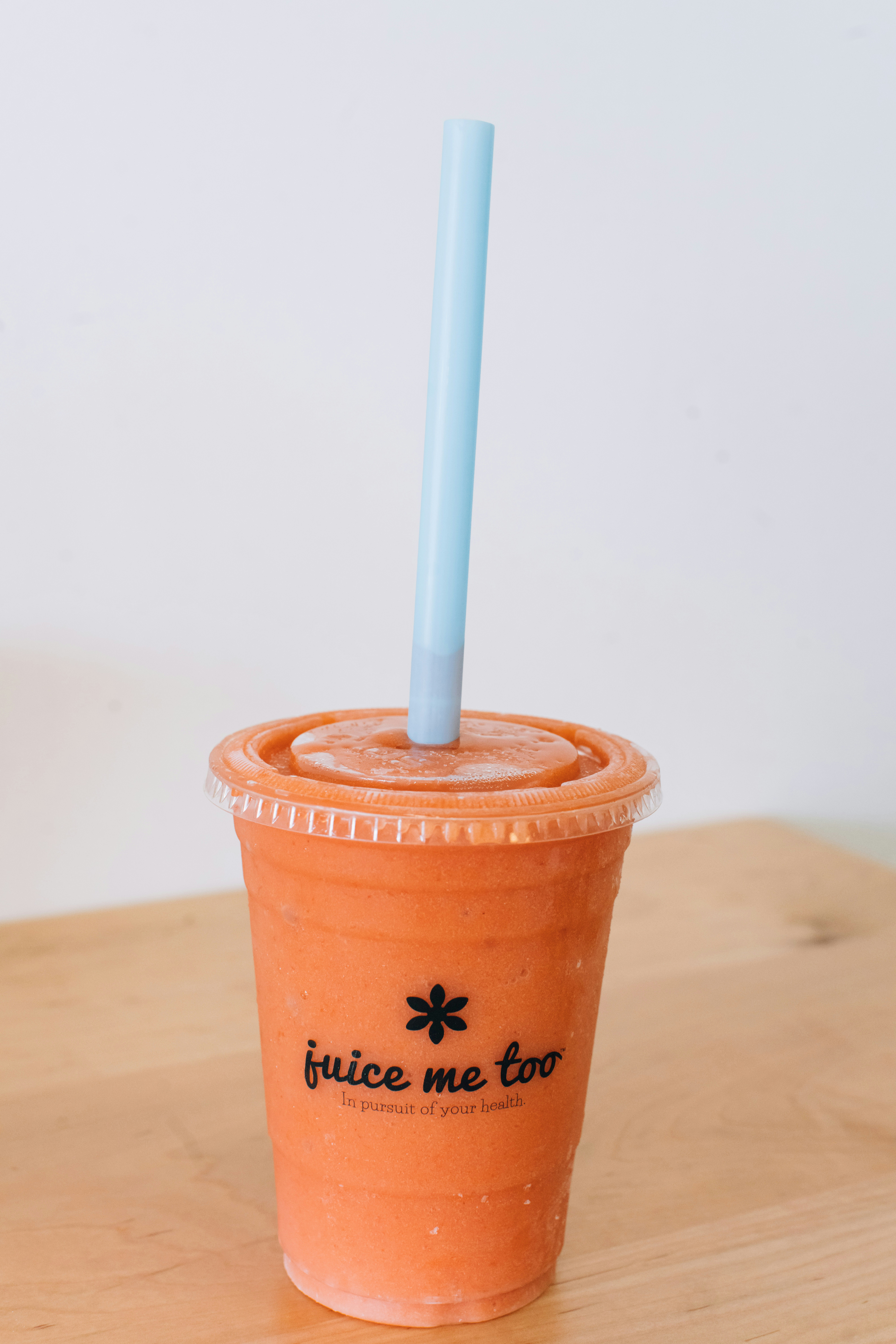 A refreshing smoothie is pictured with a straw.