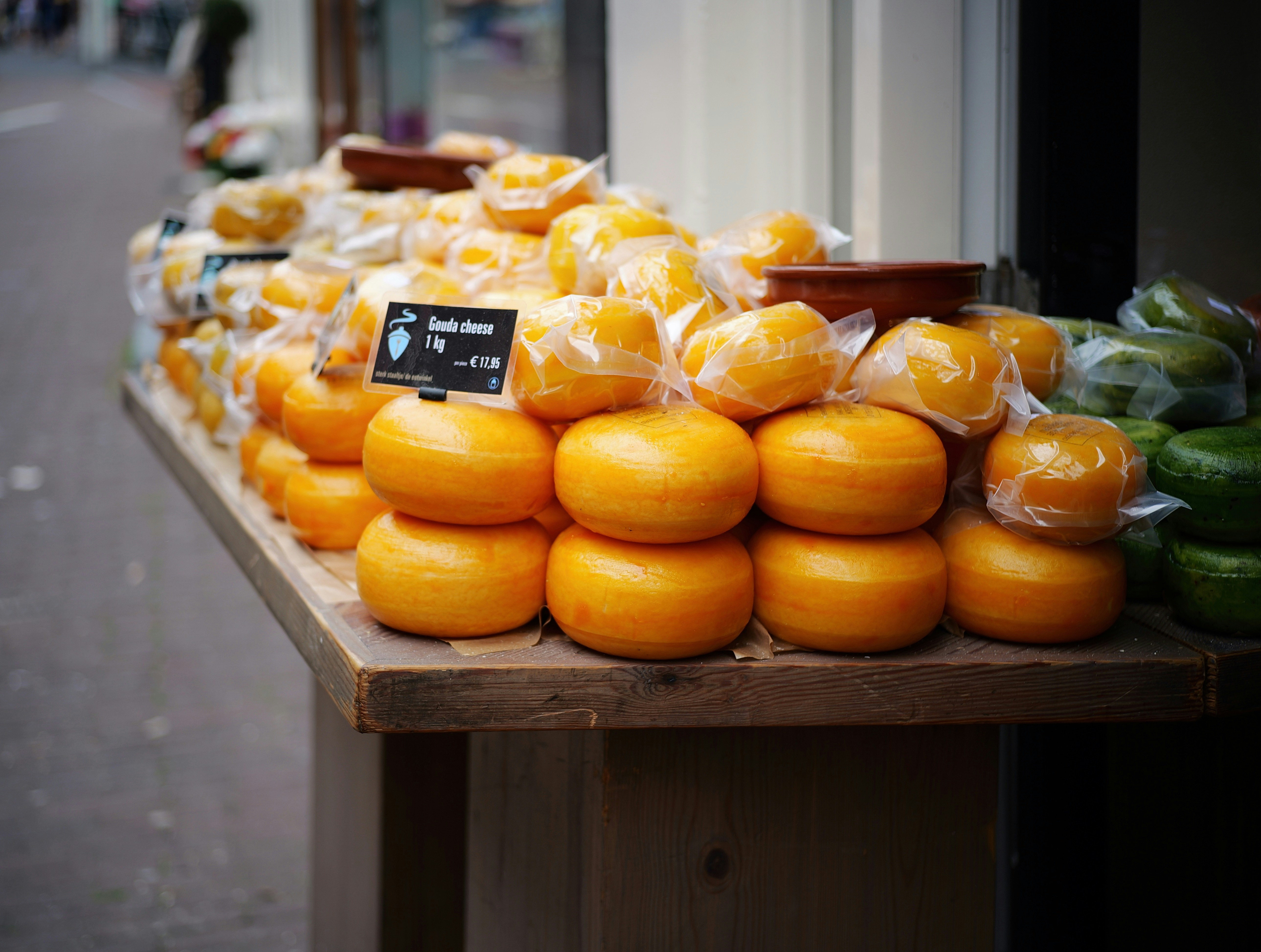 A variety of cheese wheels on display.