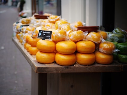 A variety of cheese wheels on display.