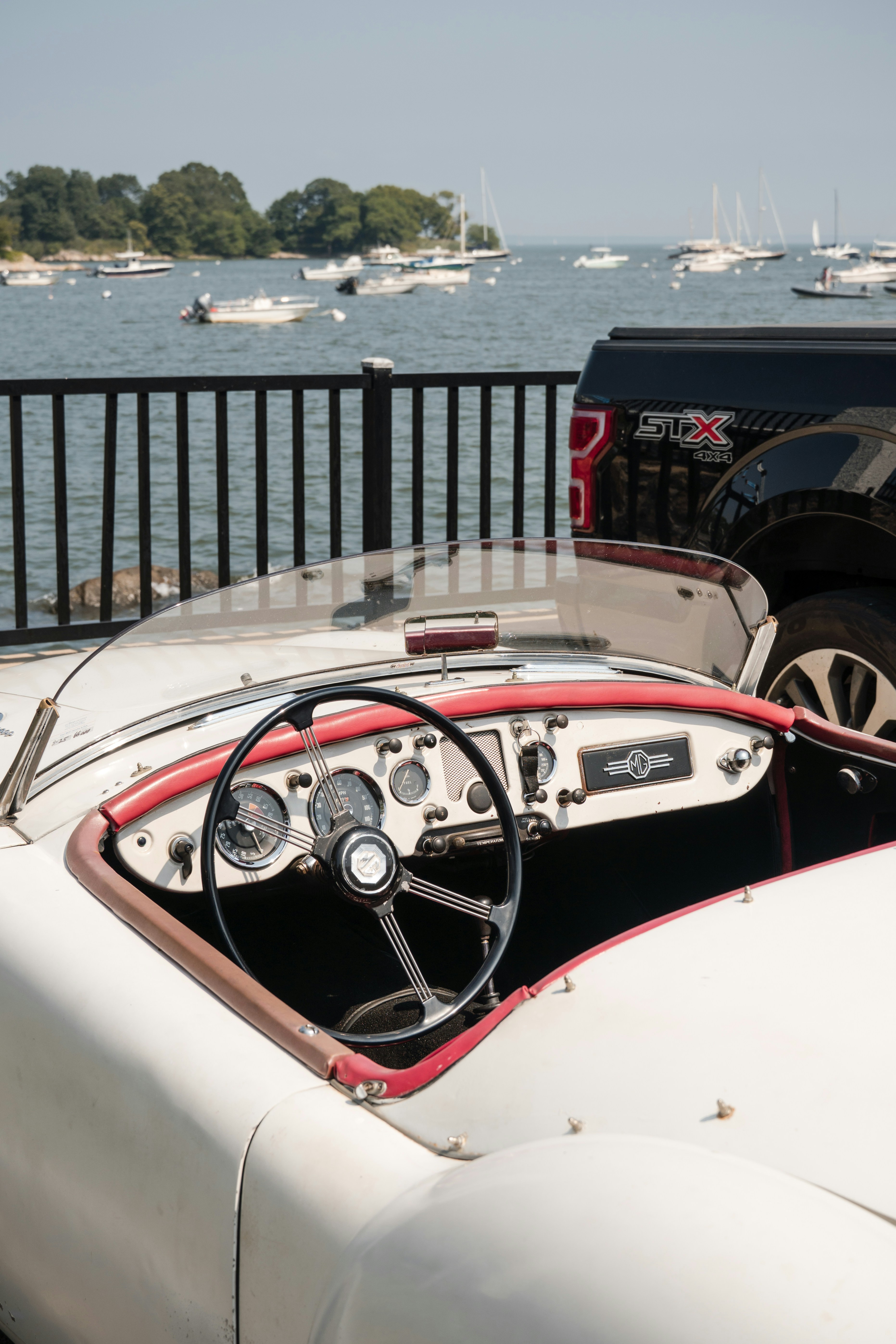 Classic car interior with a coastal backdrop.