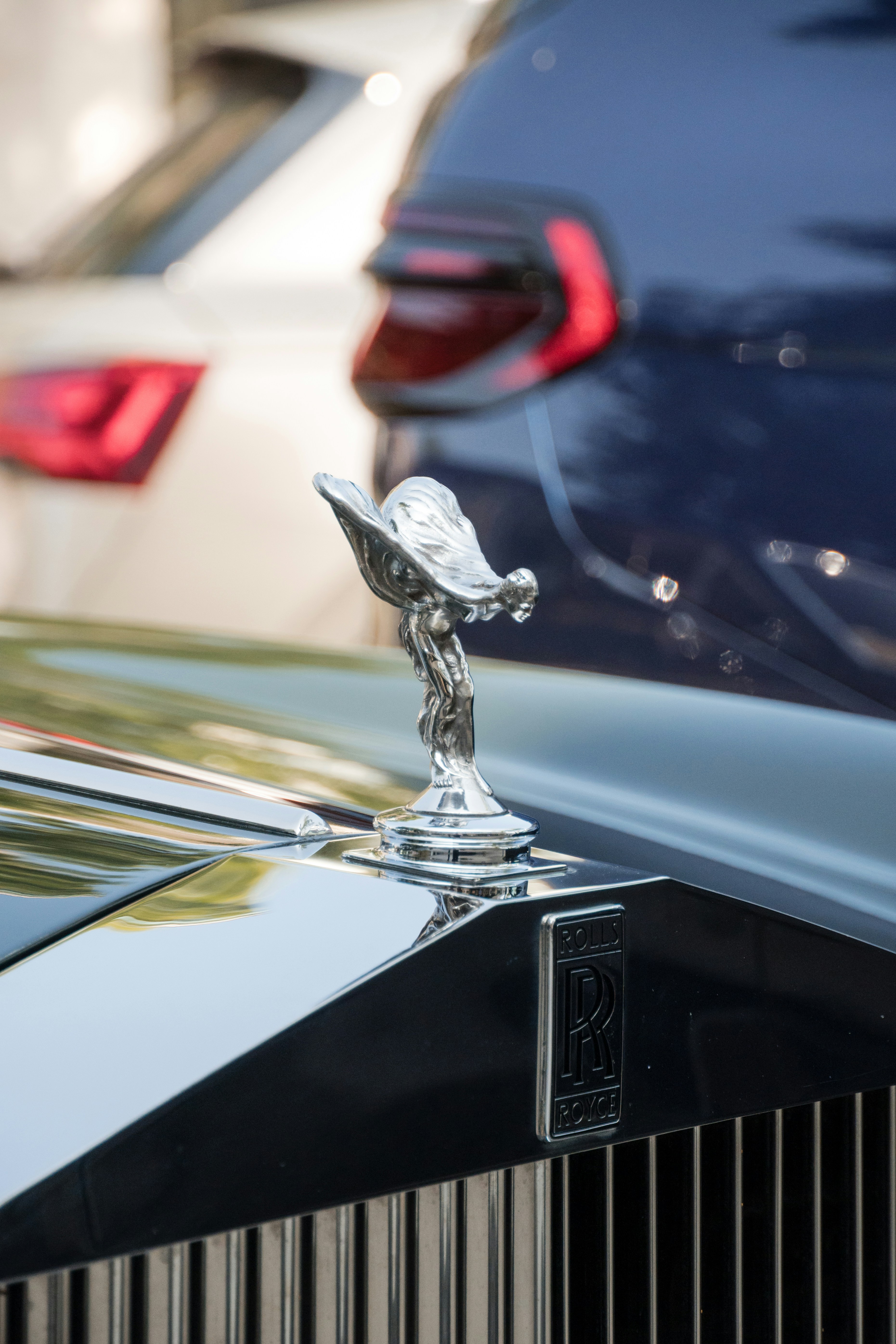 Rolls-royce hood ornament and car.