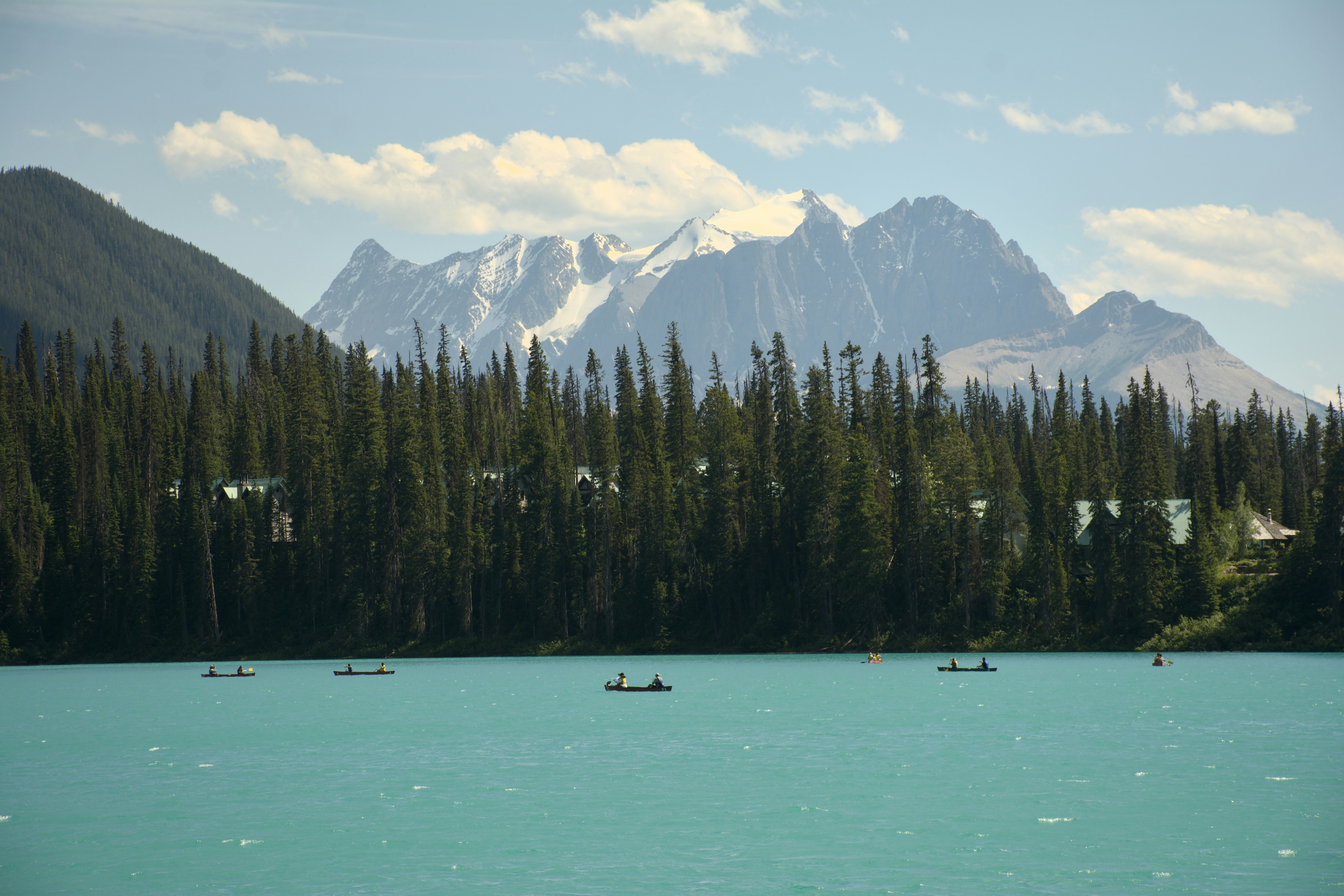 Boote auf einem türkisfarbenen See mit Blick auf die Berge.