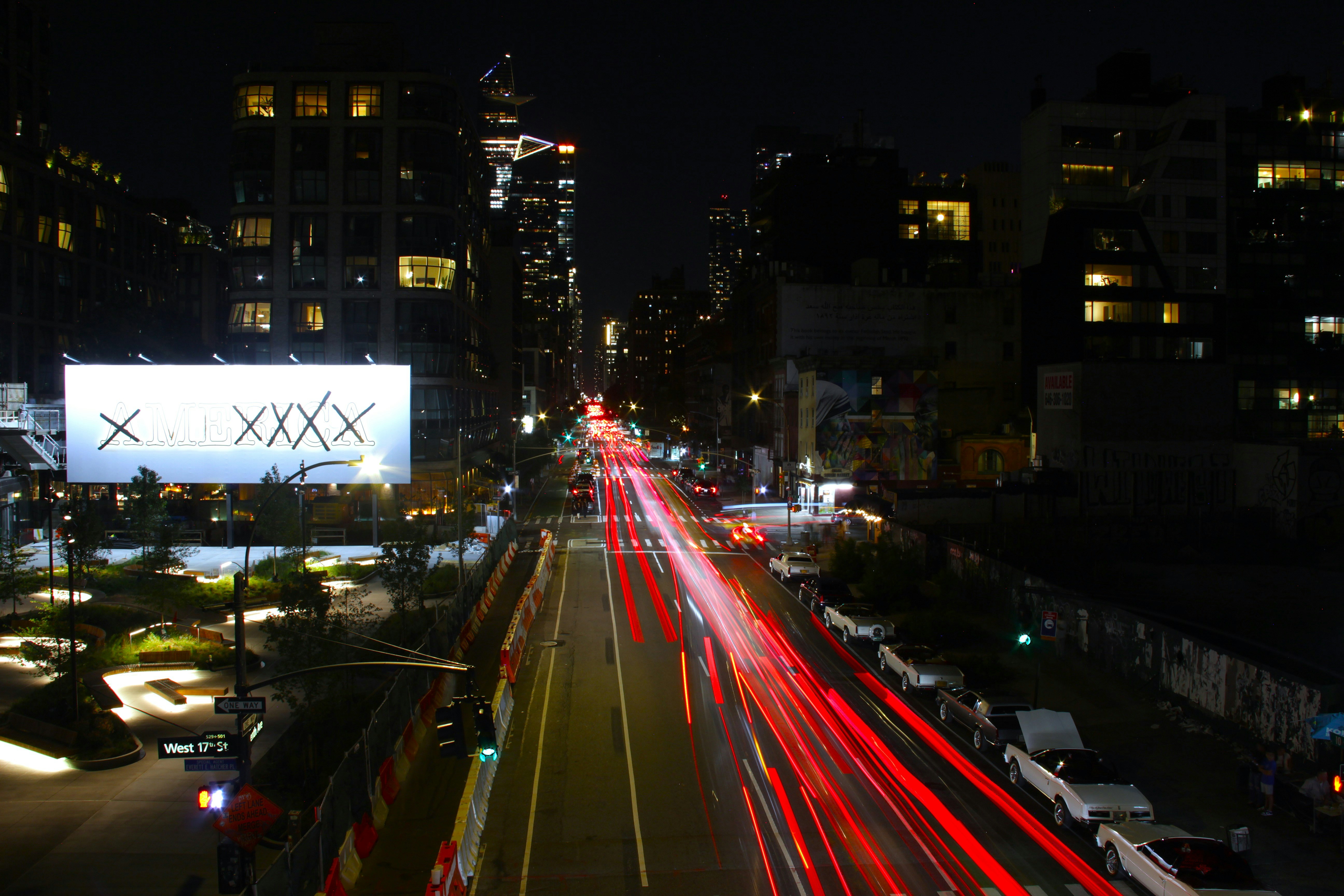 Nighttime cityscape with streaks of car lights.