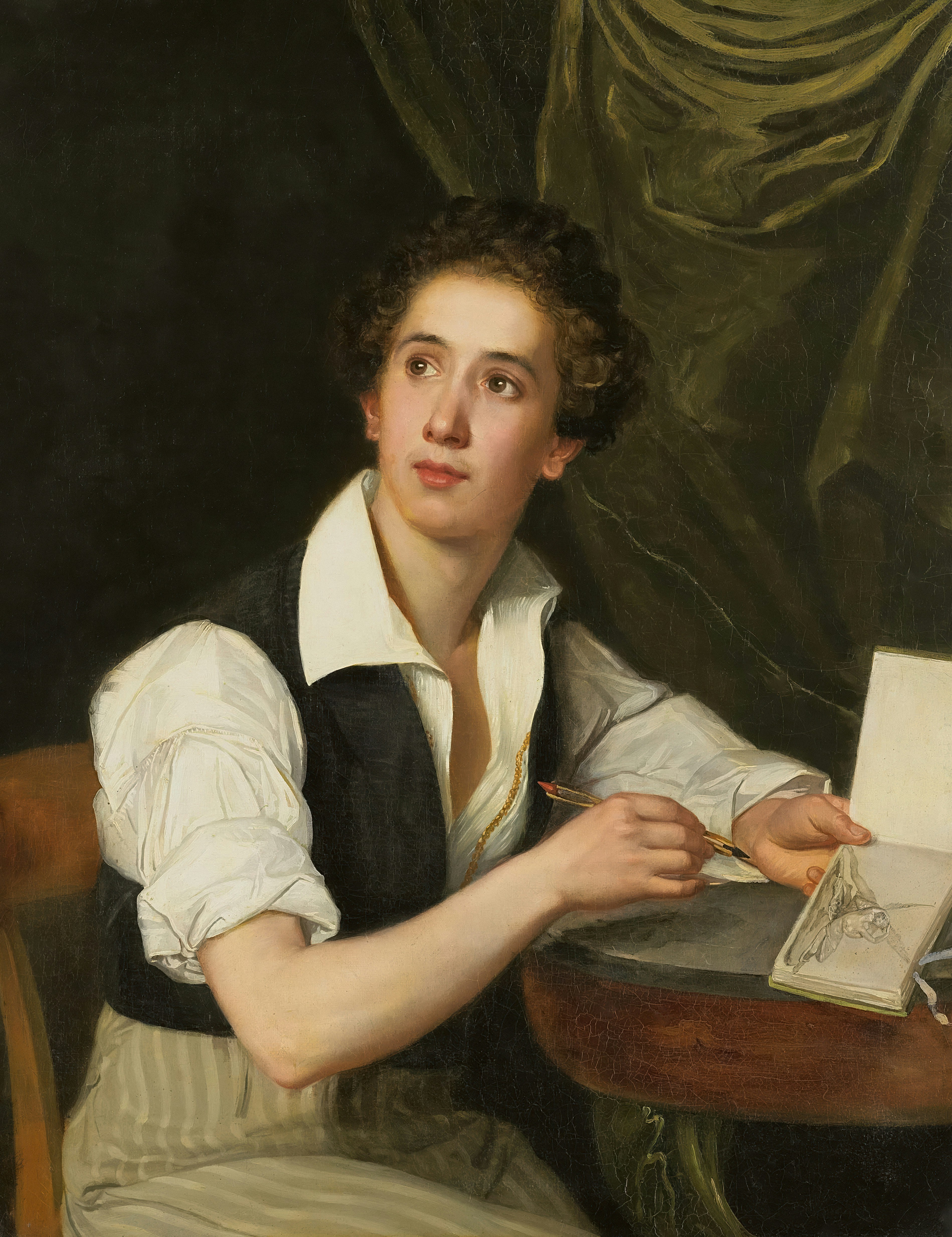 Young woman writing at a table with pen and paper.