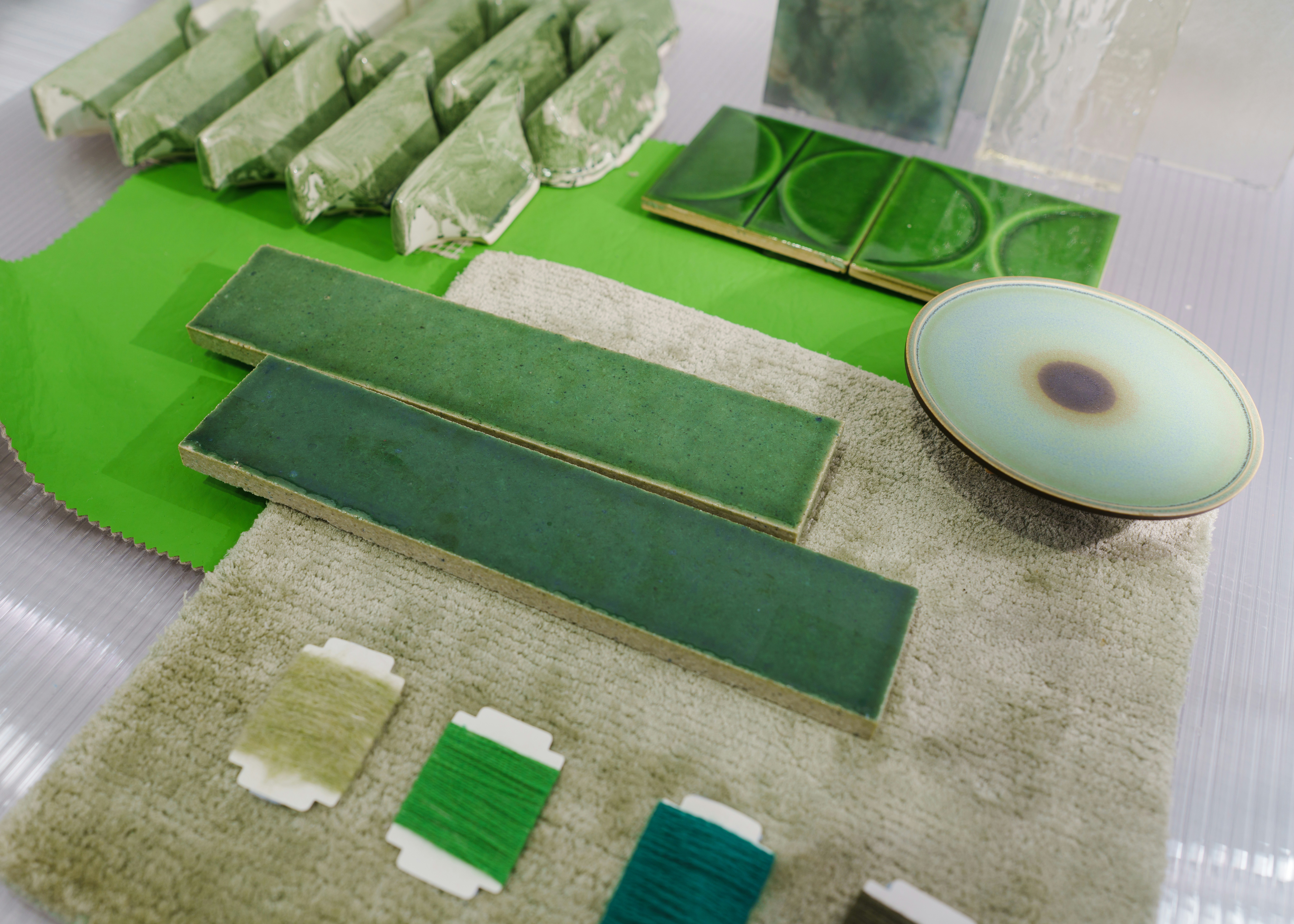 Various shades of green items are arranged on a surface.