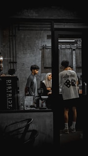 People are at a coffee shop counter.