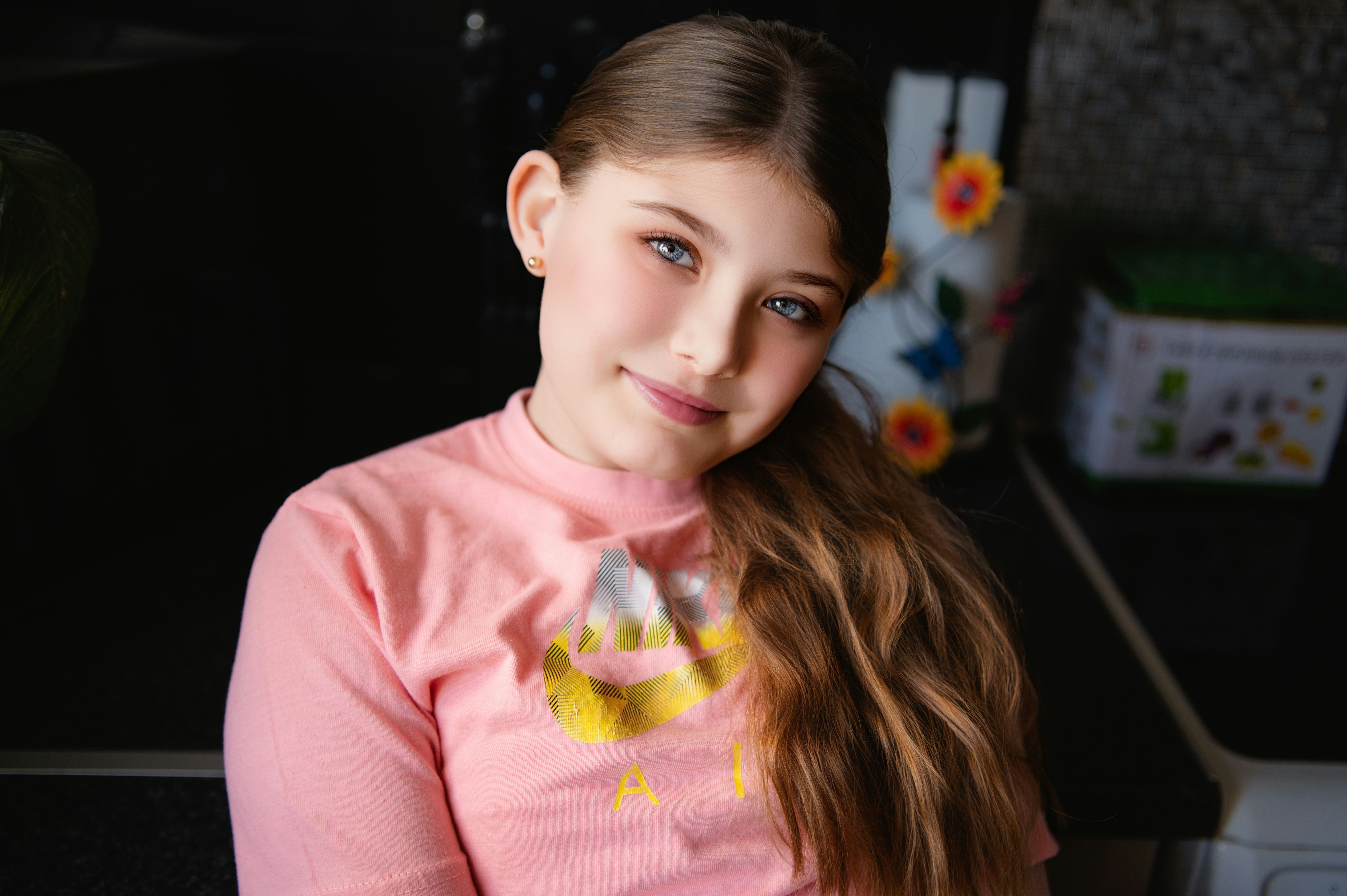 A young girl smiles happily at the camera.