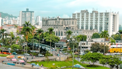 A cityscape shows buildings and trees.