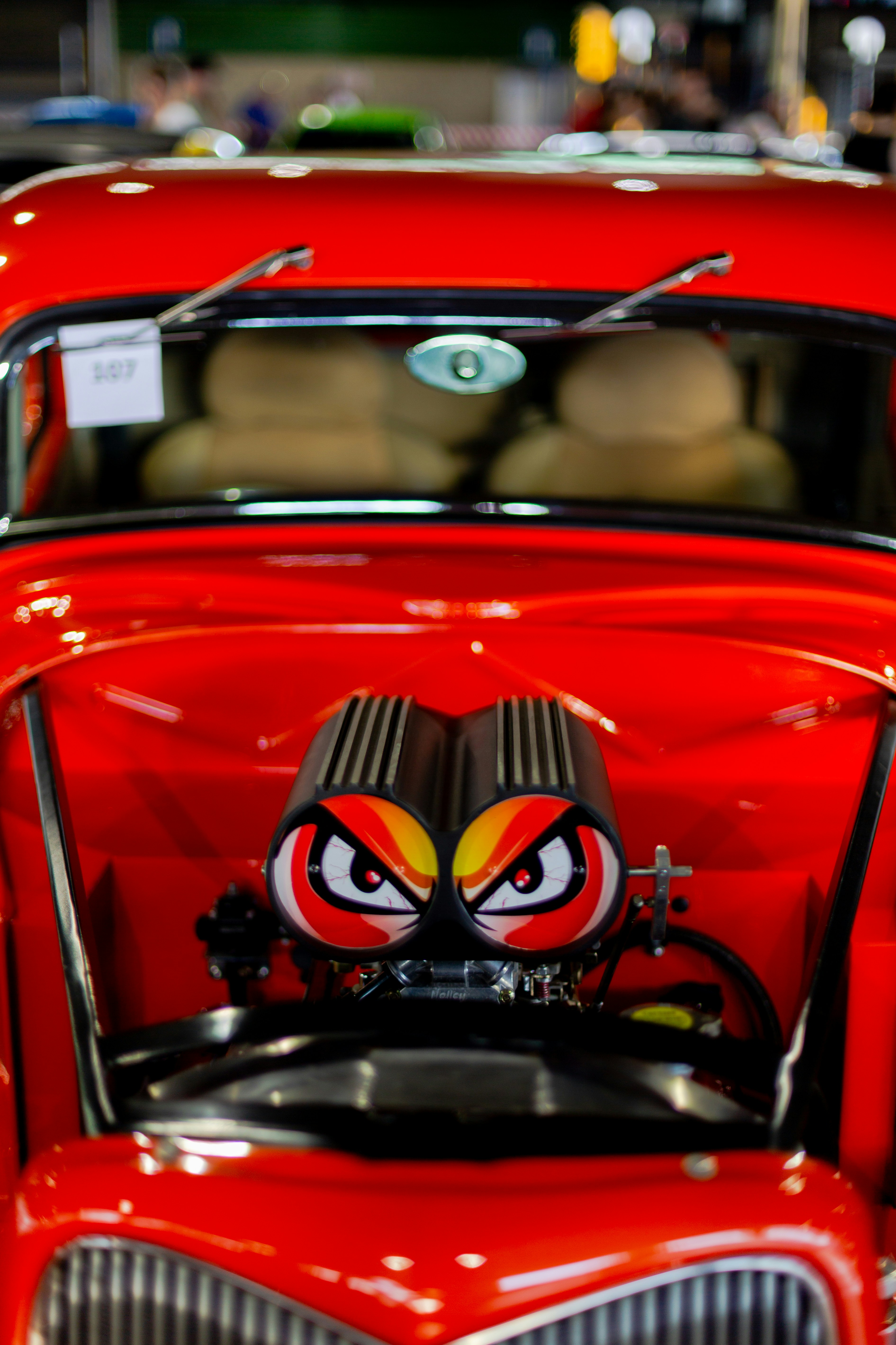 A red hot rod displays its powerful engine.