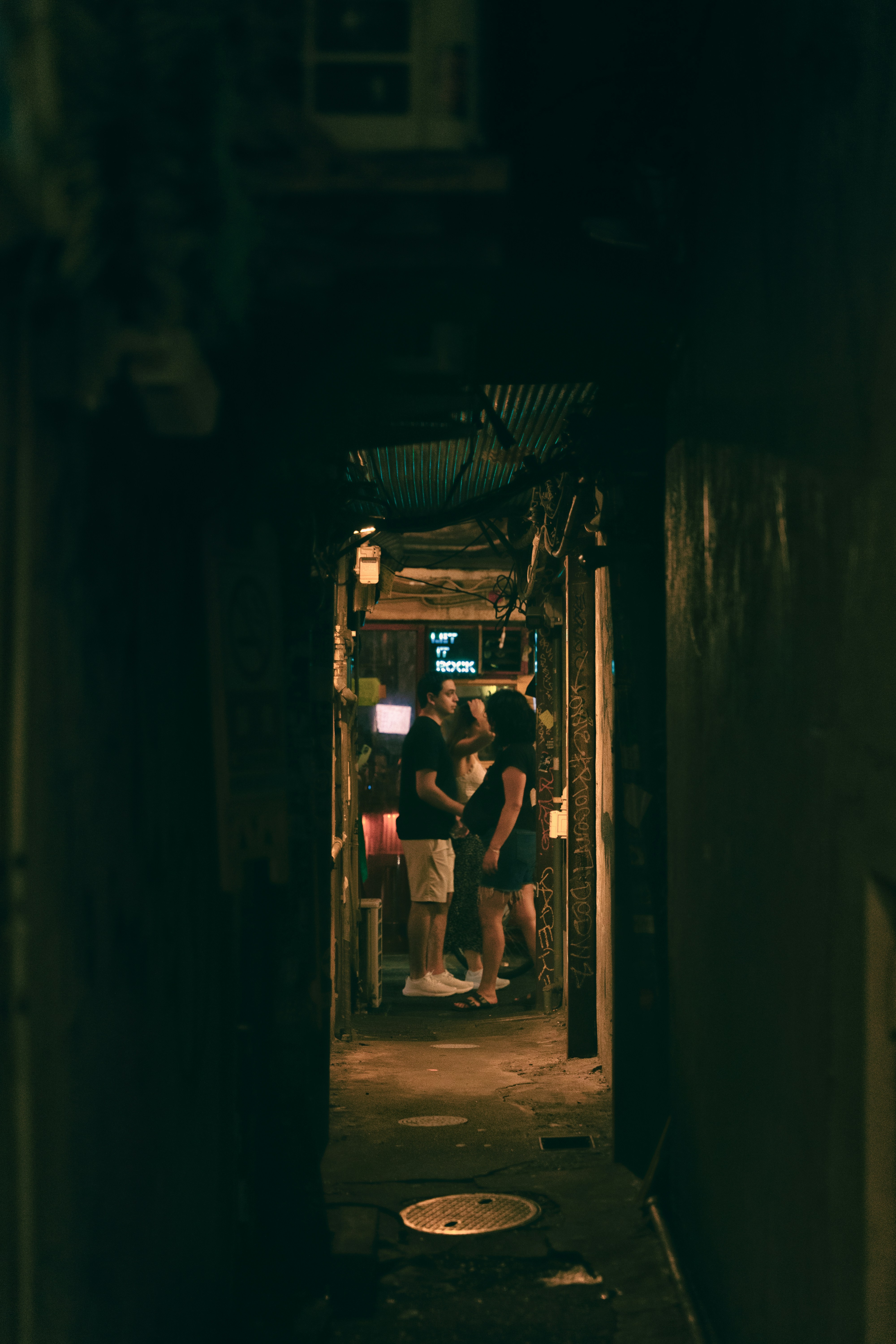 薄暗い細い路地に人々が集まっています。