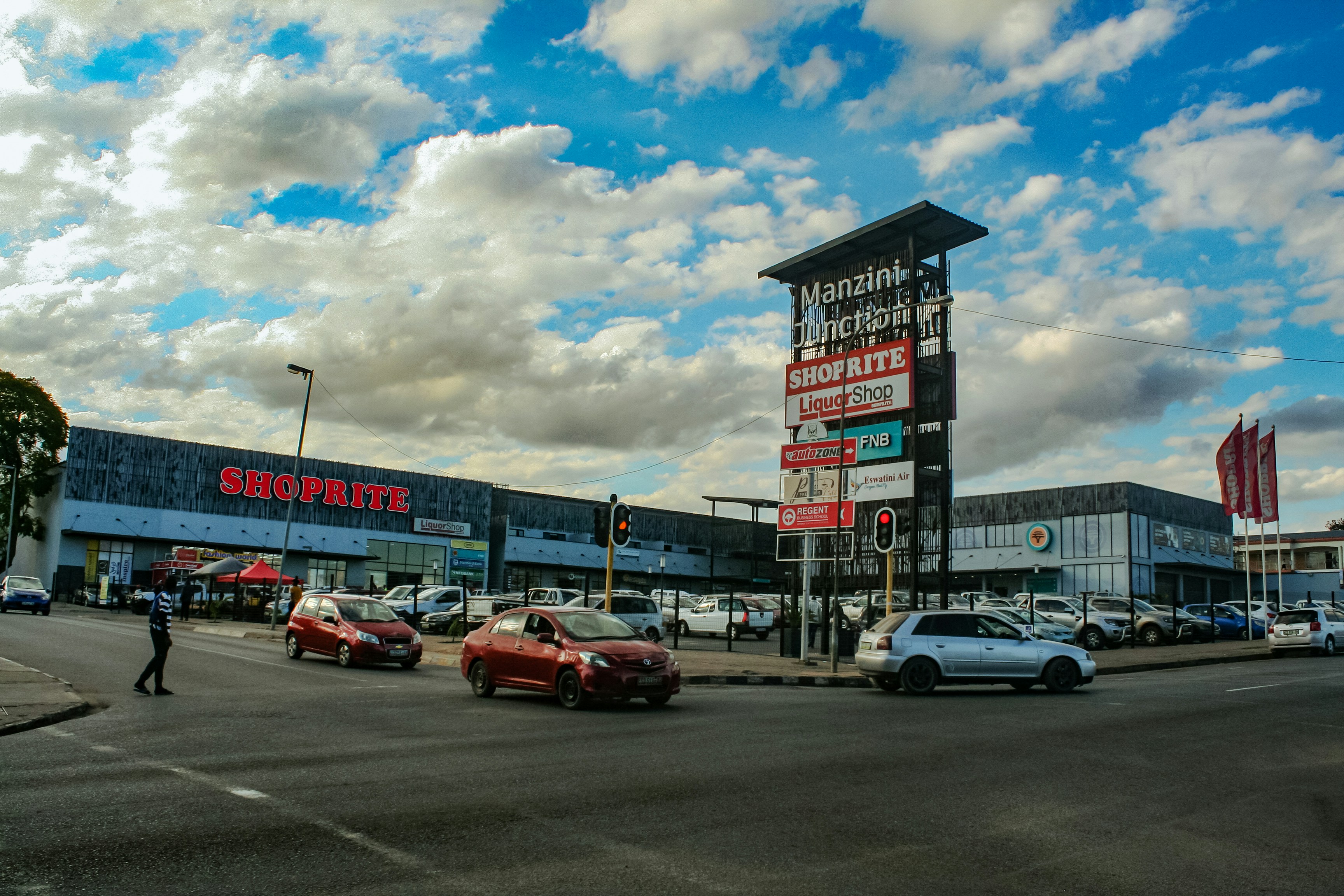 A busy street in front of a shopping center.