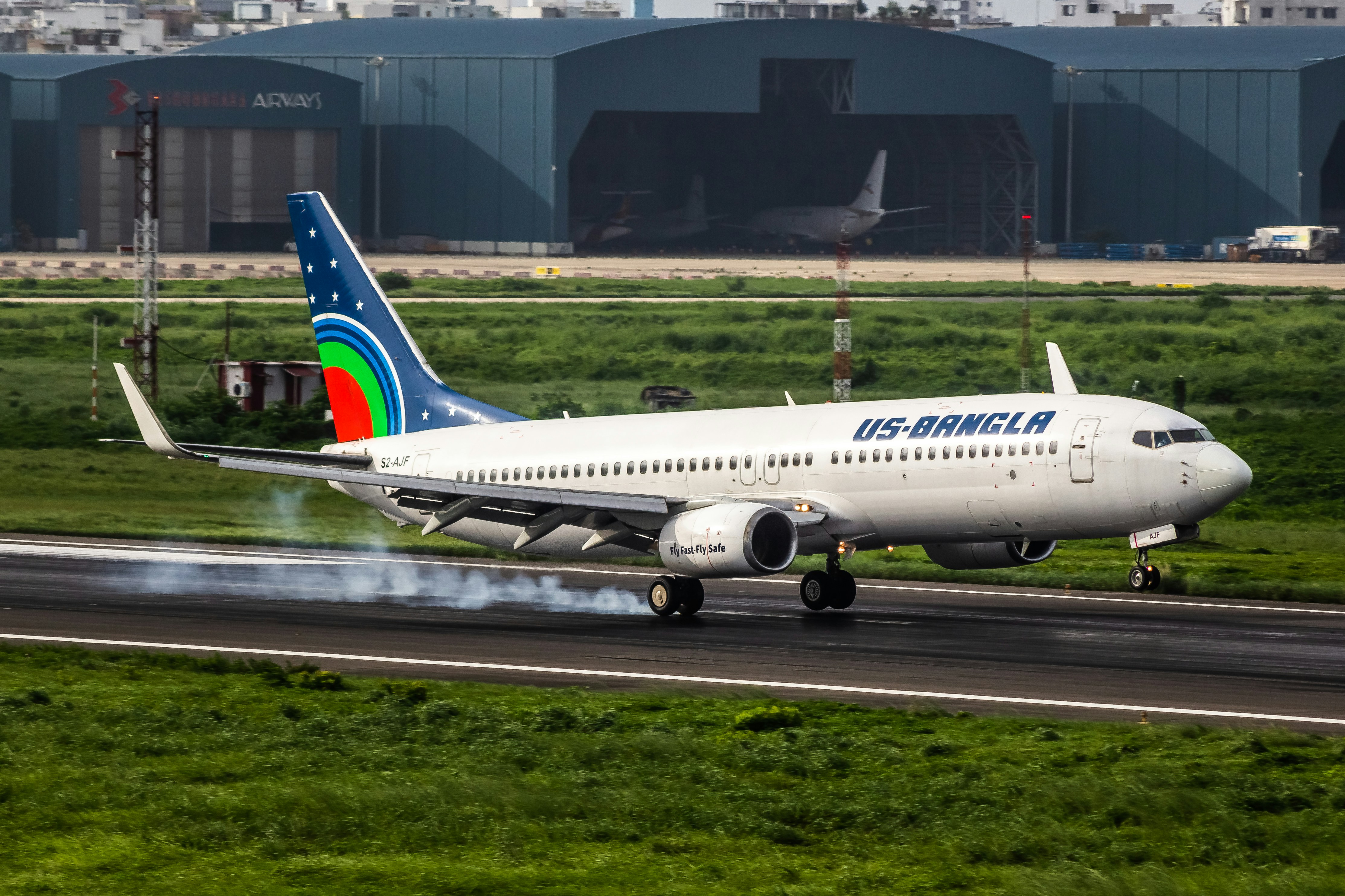 A us-bangla airplane lands on the runway.
