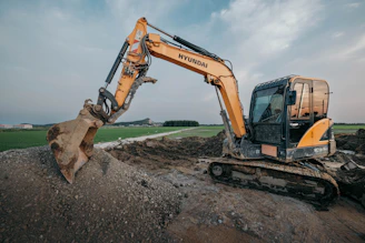 Excavator performing rough grading