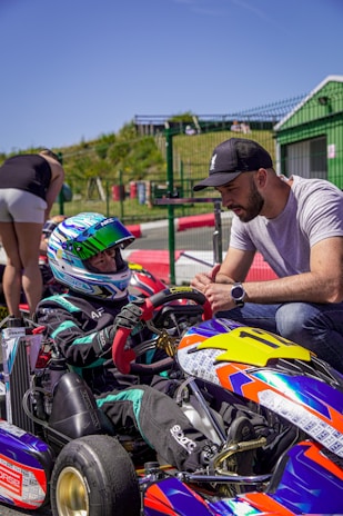 Man talking to child in go-kart