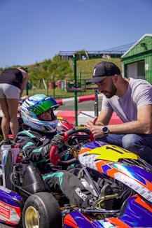 Man talking to child in go-kart