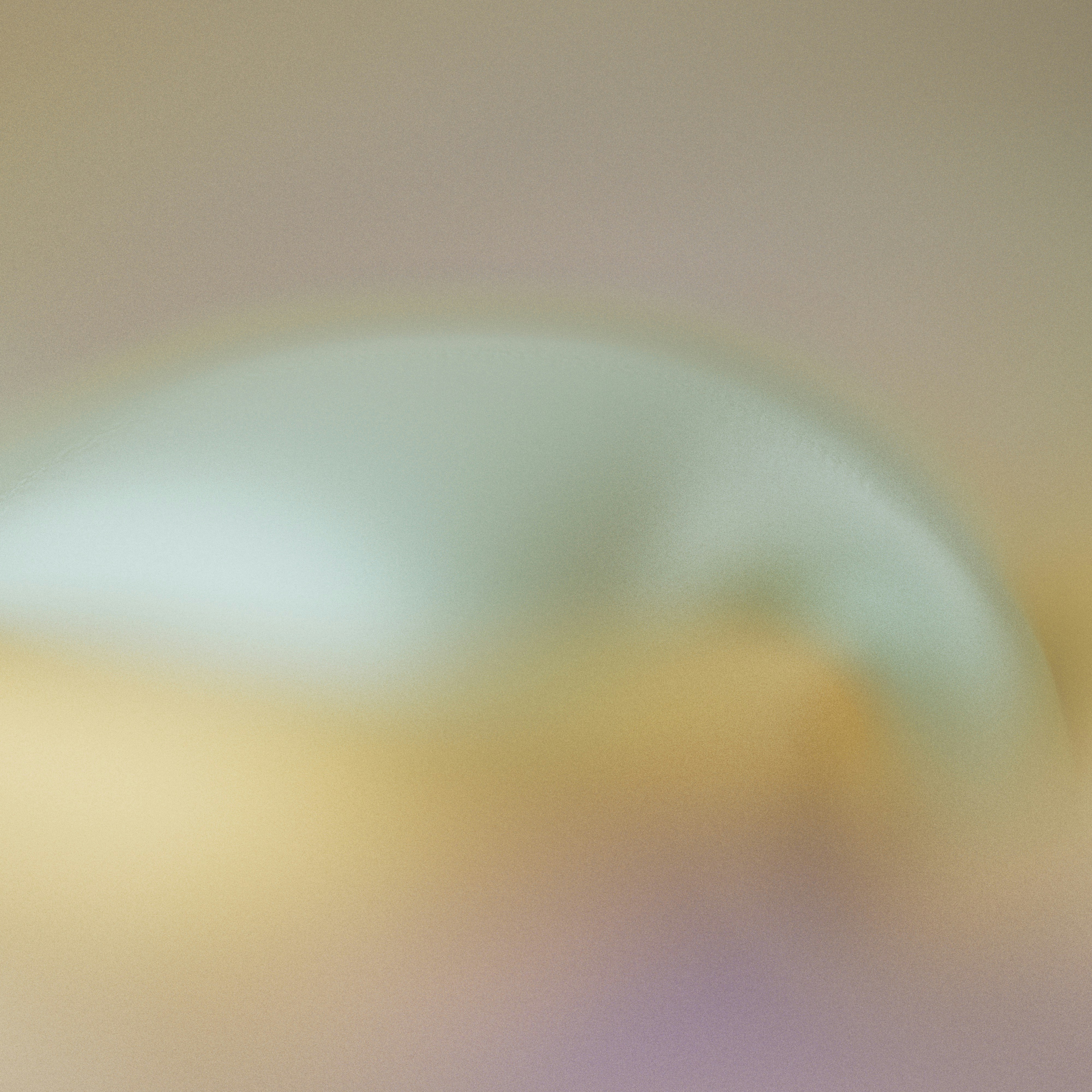 A soft abstract gradient of pale green, yellow, and purple tones
