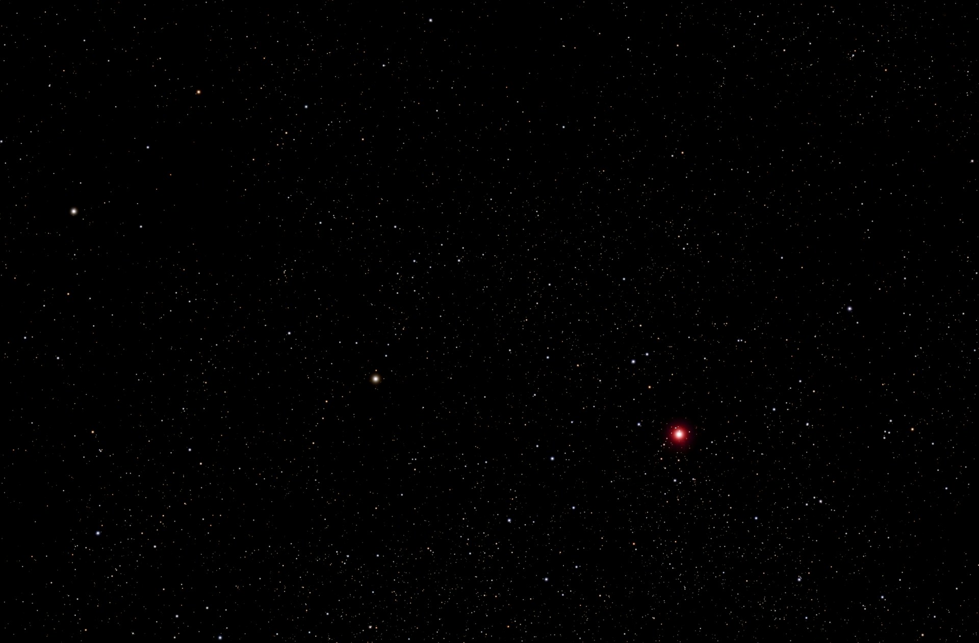 Stars dot the dark expanse of space.