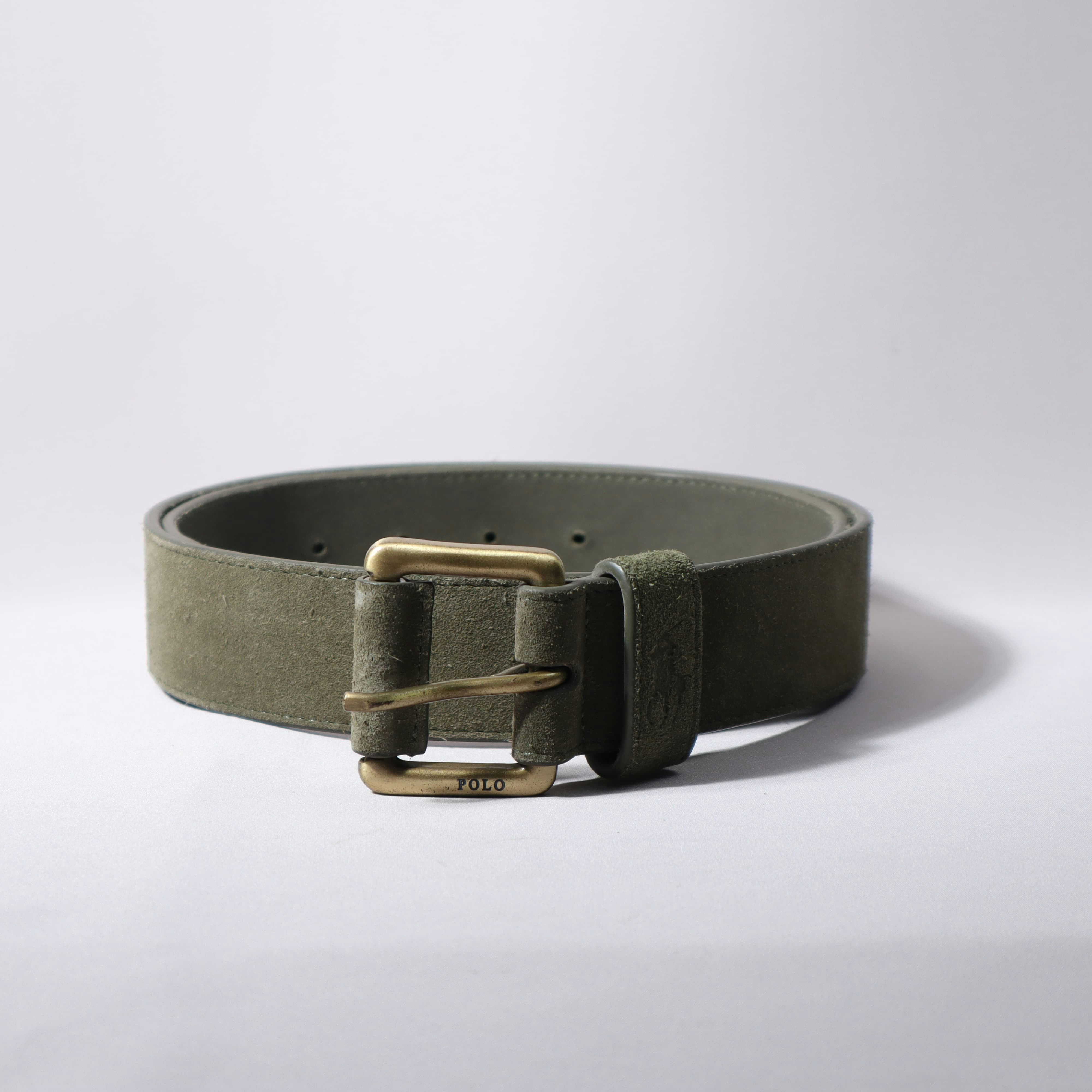 A green belt with a golden buckle.