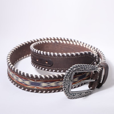 A stylish, patterned belt with an ornate buckle.