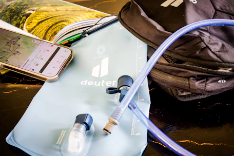 Hiking gear: water bladder, backpack, and phone map.