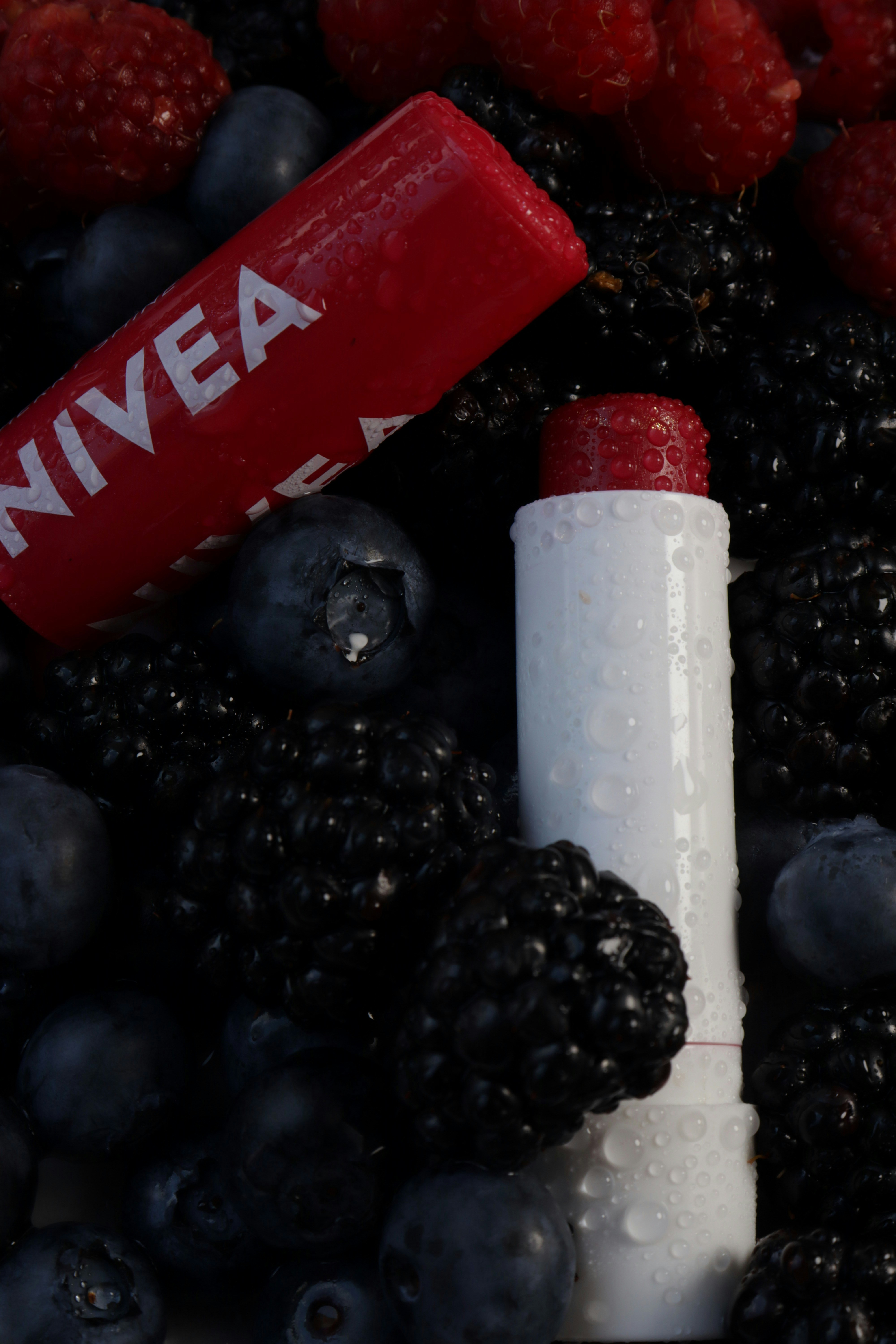 Nivea lip balm surrounded by berries.
