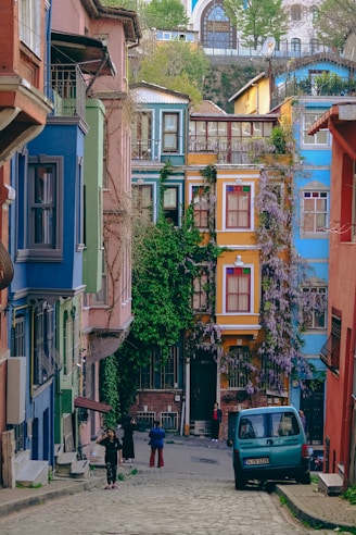 Colorful buildings line a cobblestone street in istanbul.