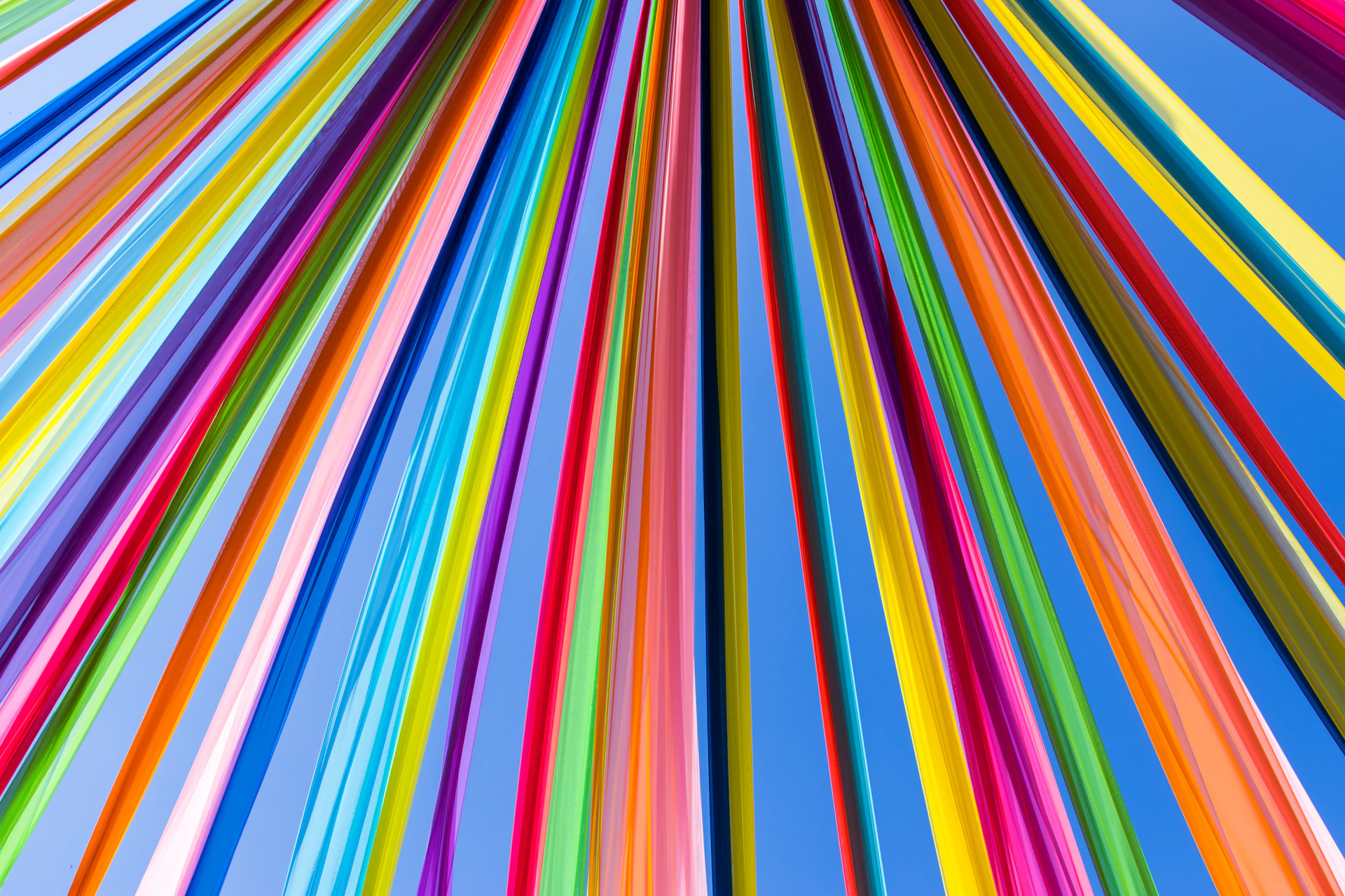 Colorful vertical stripes radiate outwards from a center.