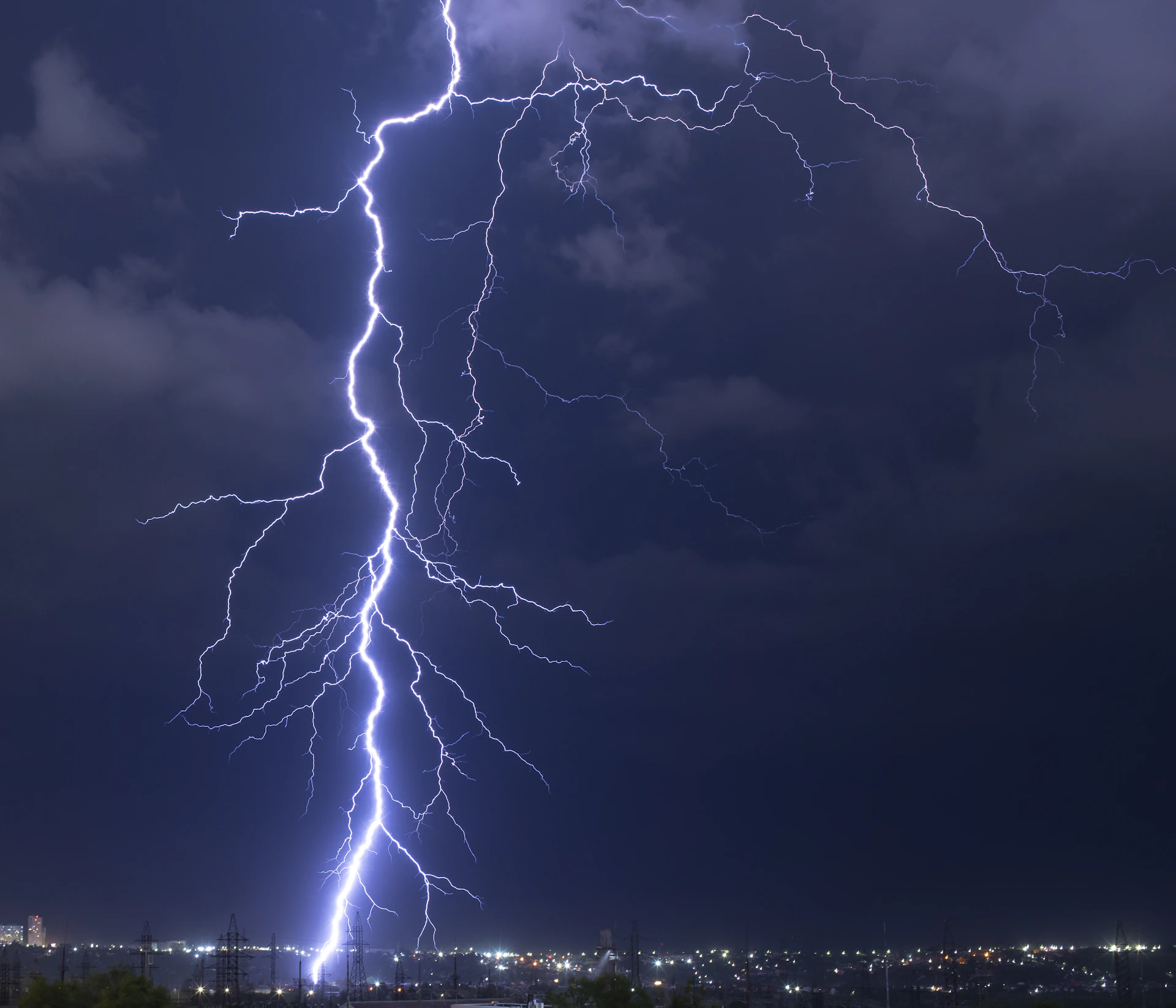 Lightning strikes against a dark, stormy sky.