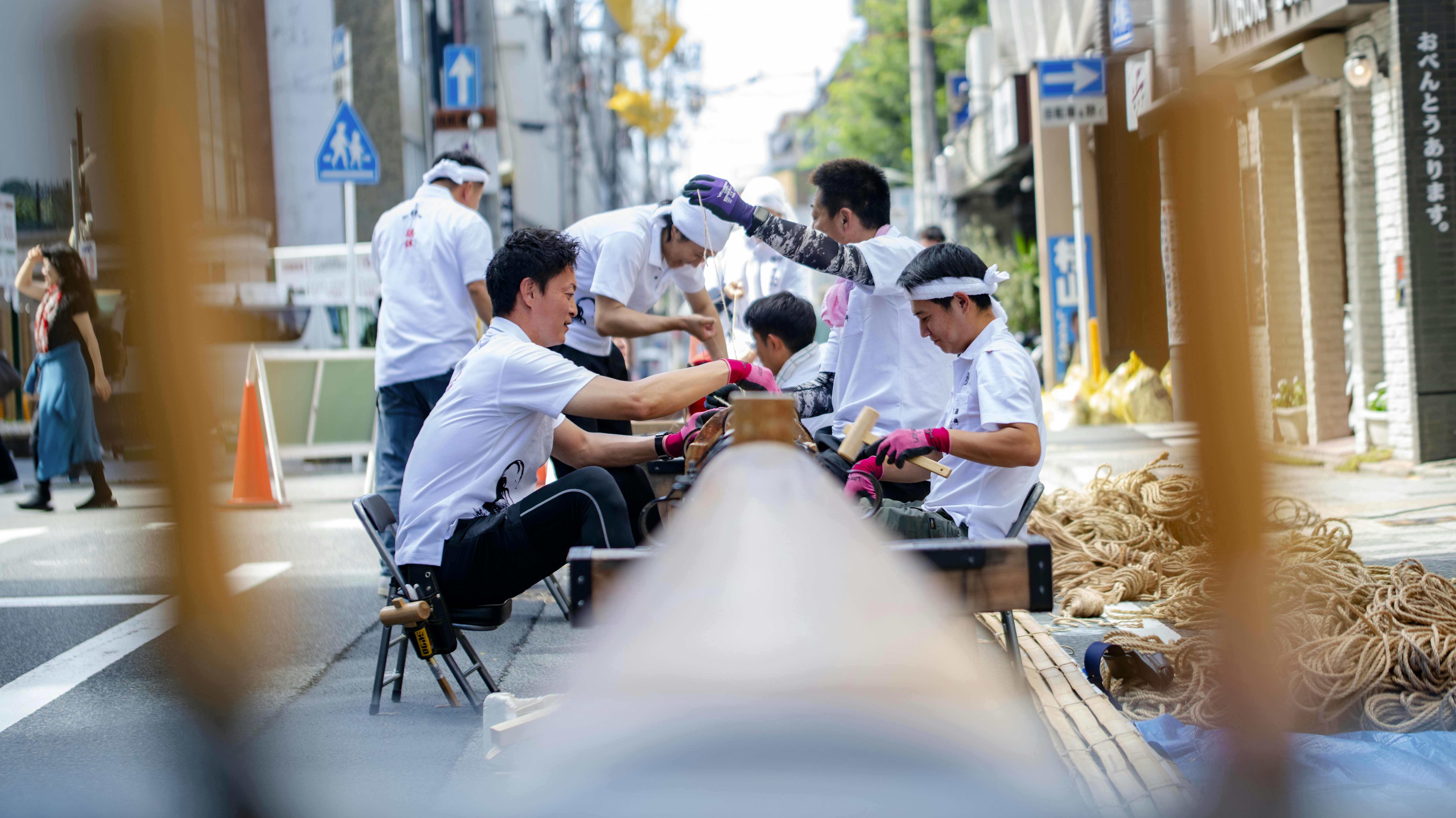 People prepare for a traditional festival in the street.