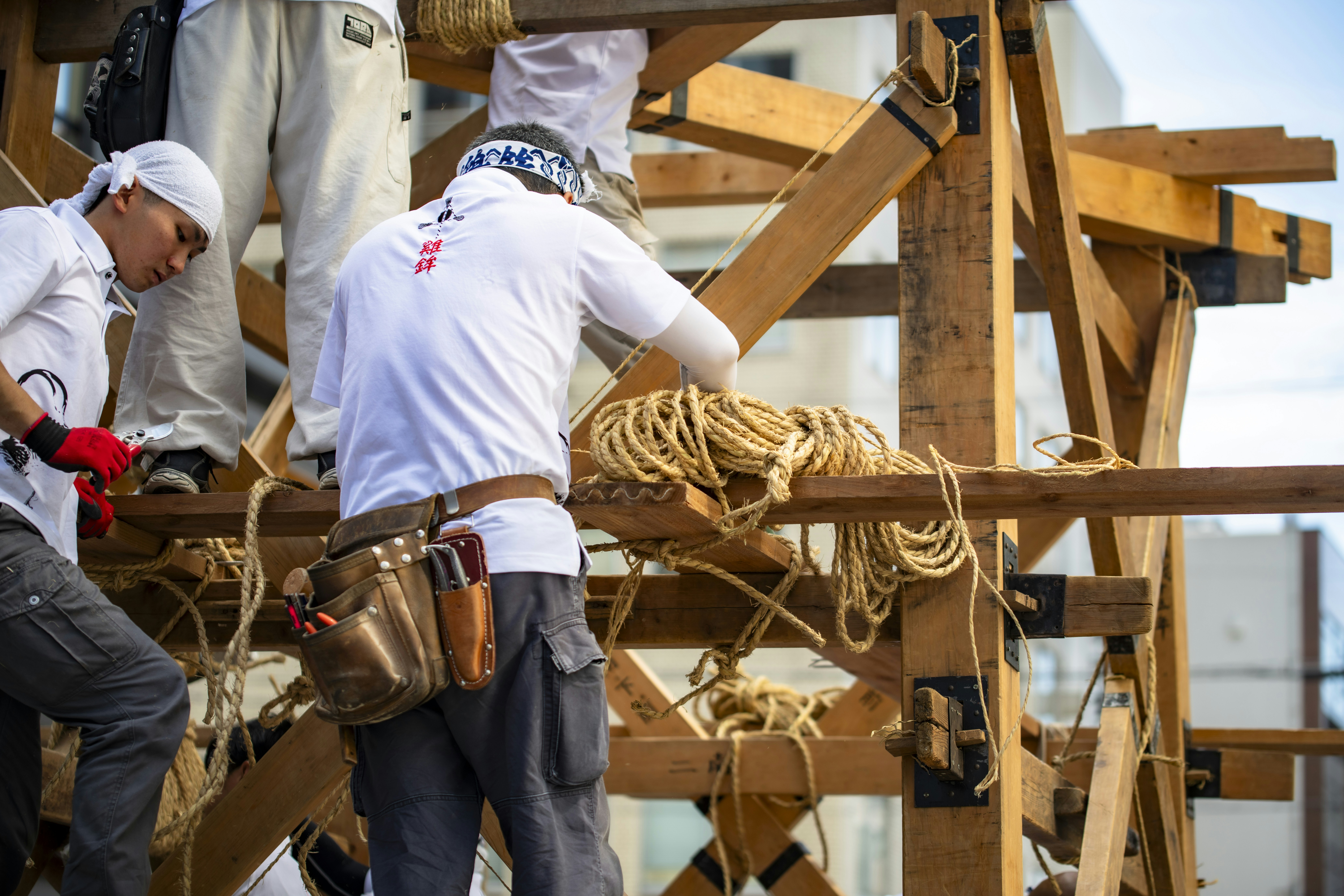 Workers build wooden structures.