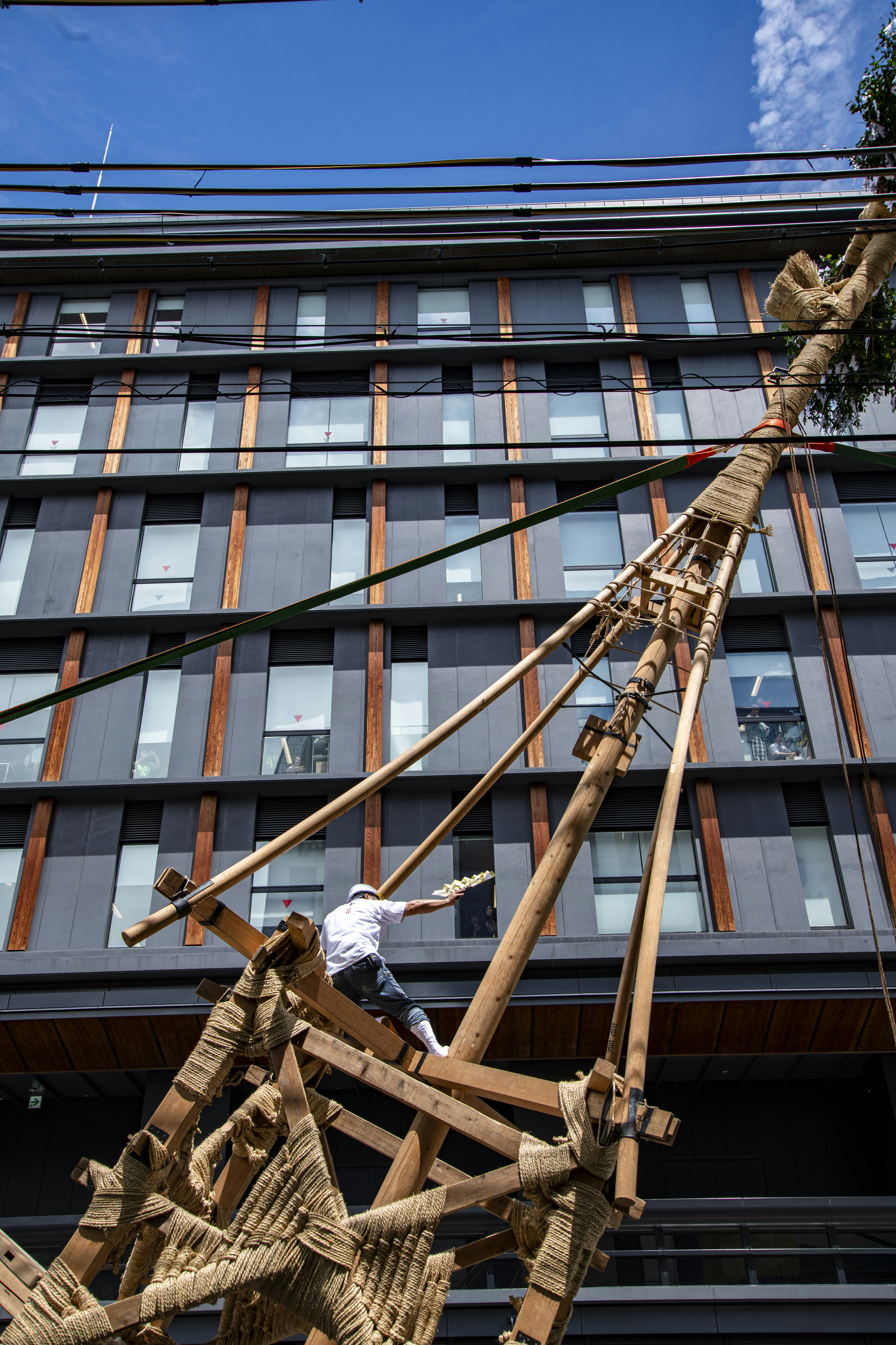 A man is working on a wooden structure.