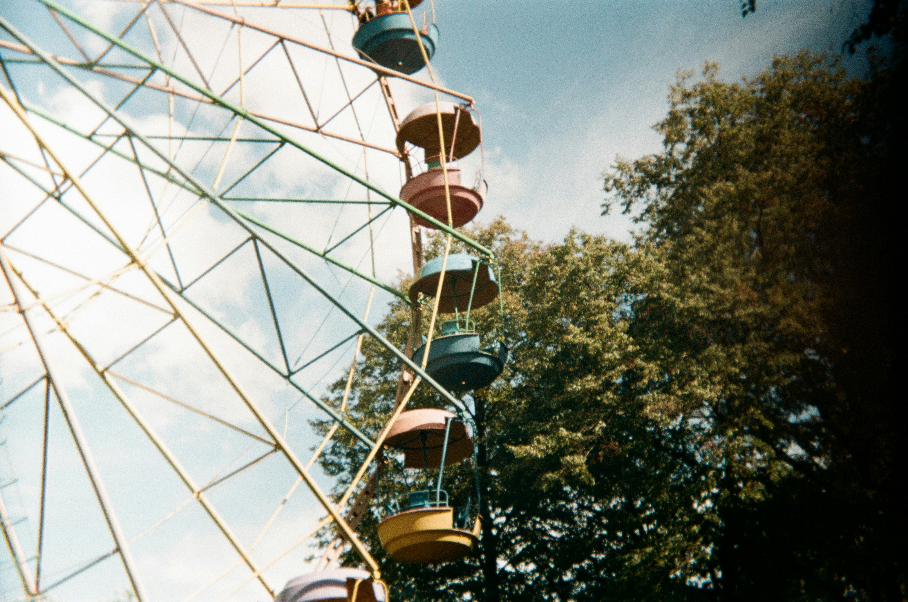 Here's a caption: a ferris wheel rises towards the sky.