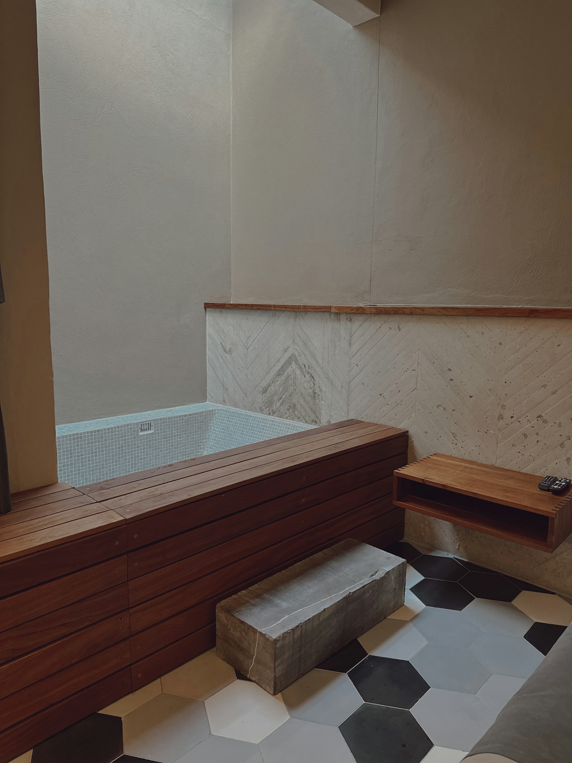 Cozy bathroom features a sunken tub and stylish accents.