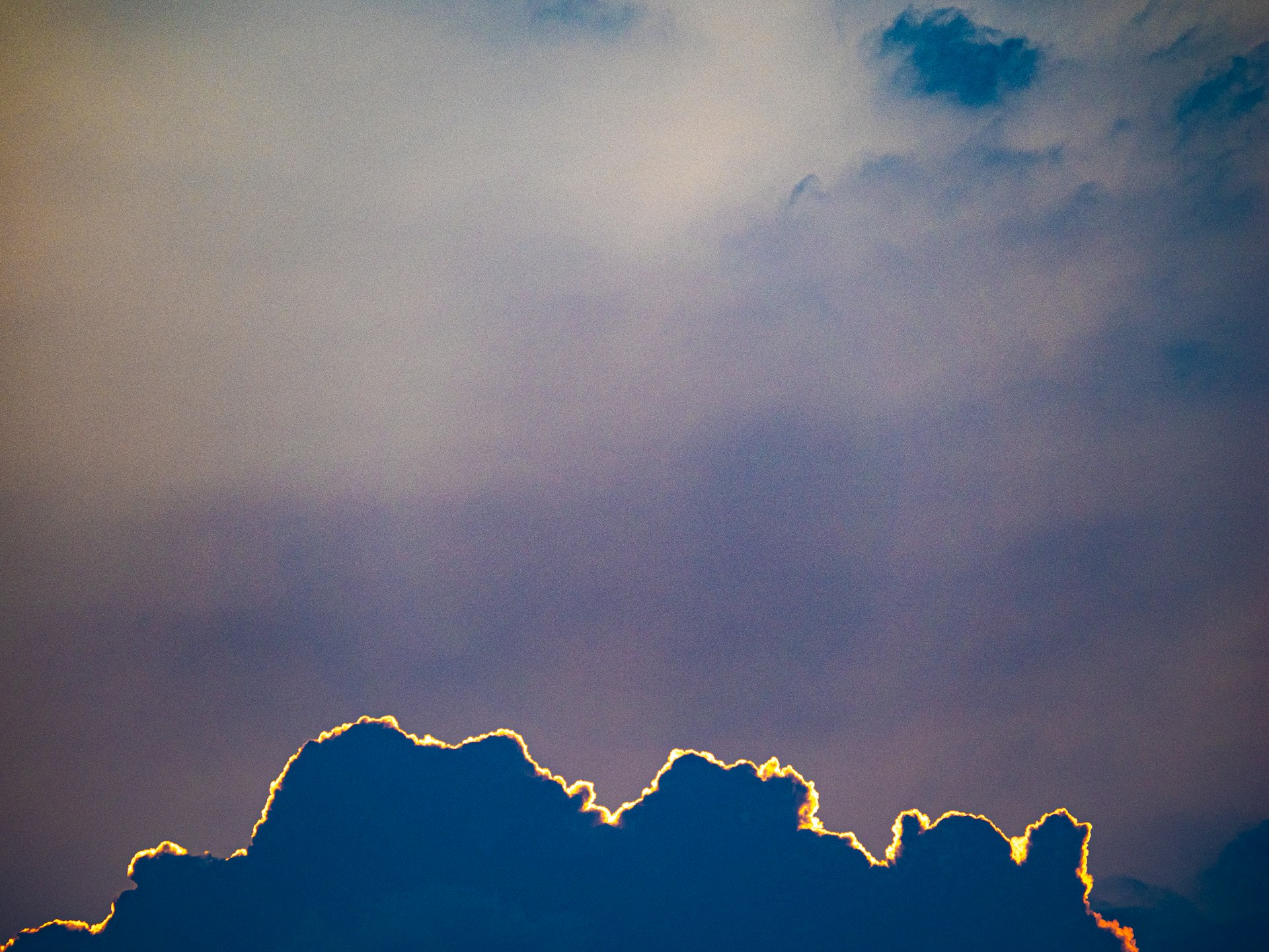 Clouds glow in the sky during the sunset.