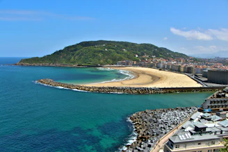 A beautiful coastal view with beach and hills.