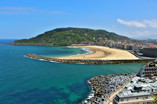 A beautiful coastal view with beach and hills.