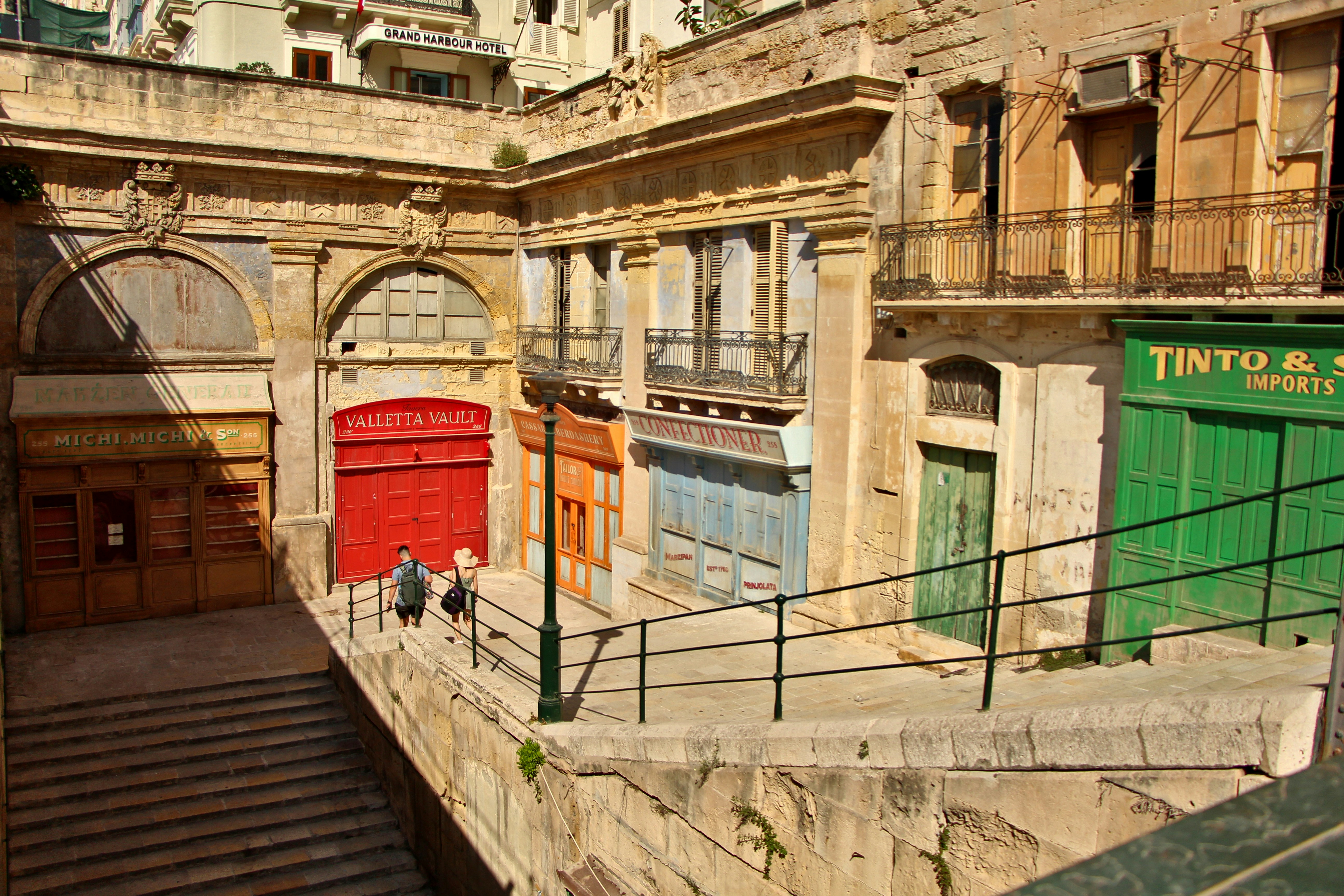 Old buildings with shops and people are visible.
