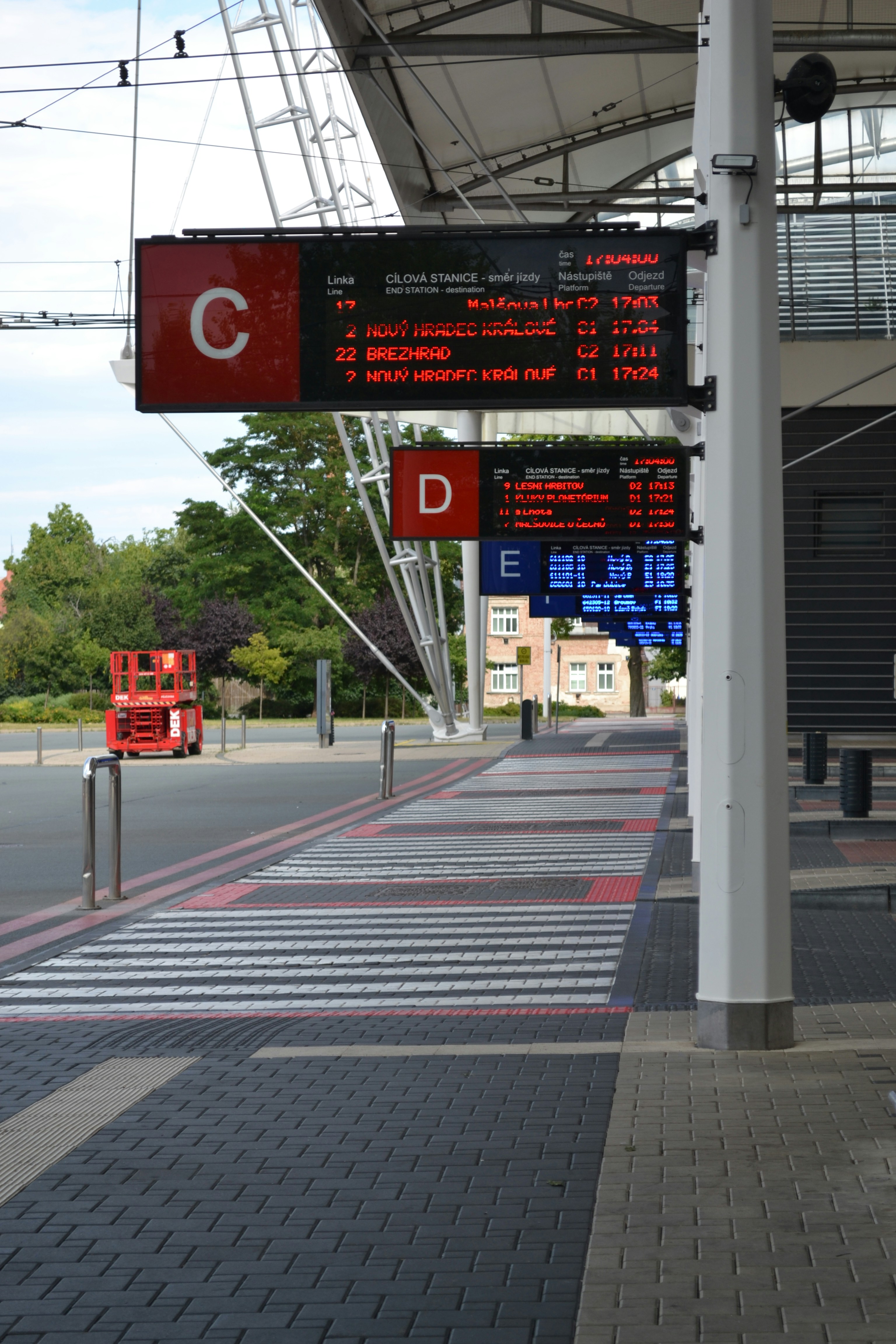 Train station signs display departure times.