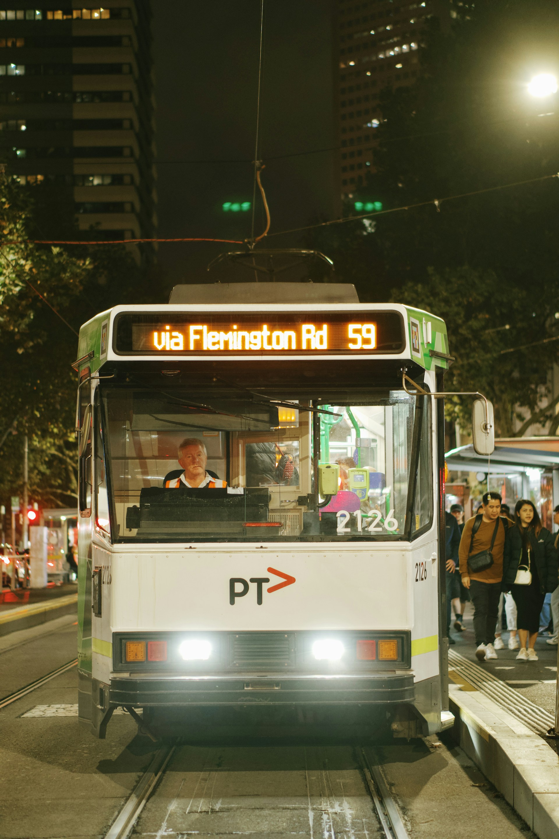 A tram arrives at a station in the city.