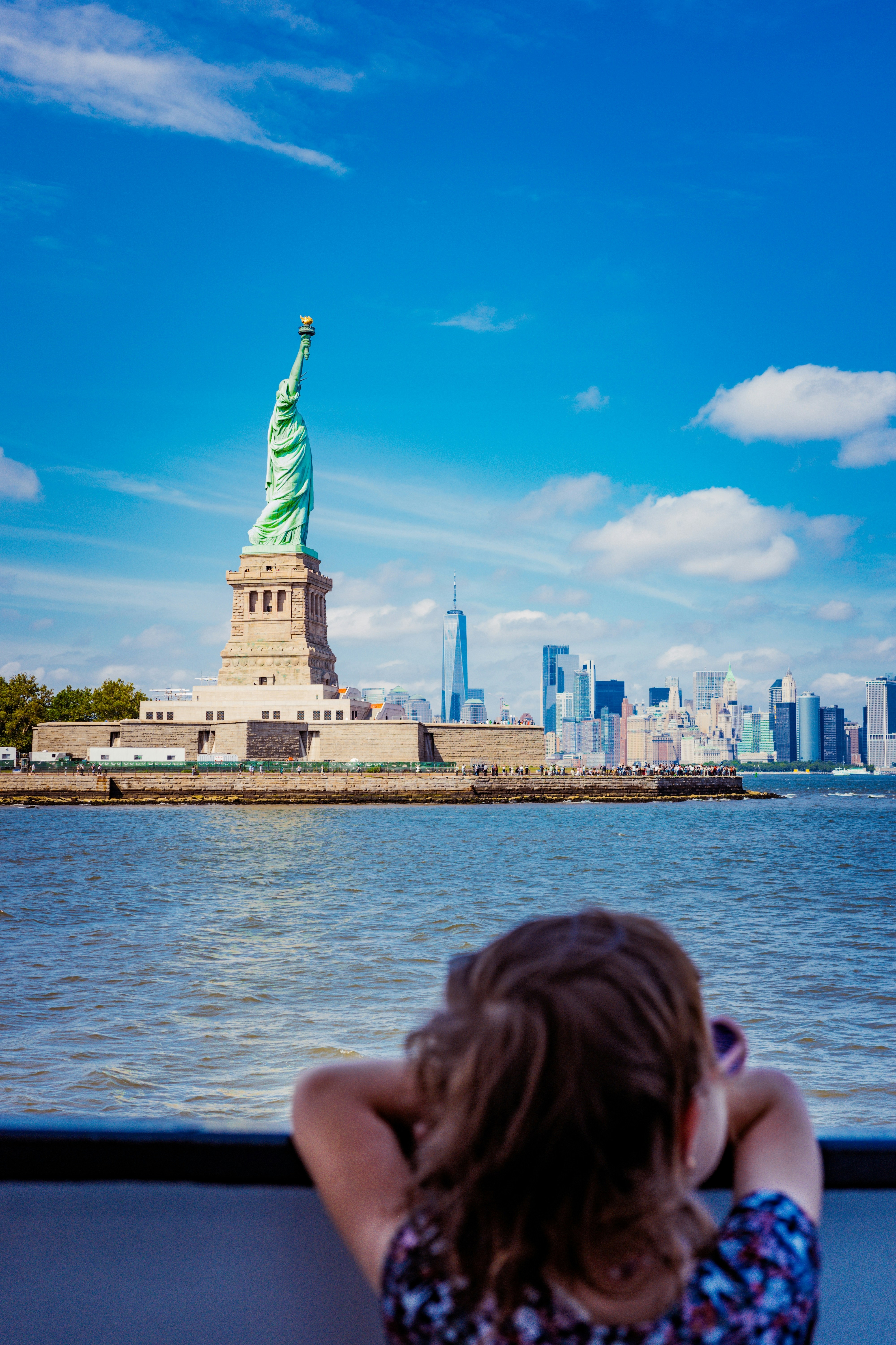 A young child views the statue of liberty.